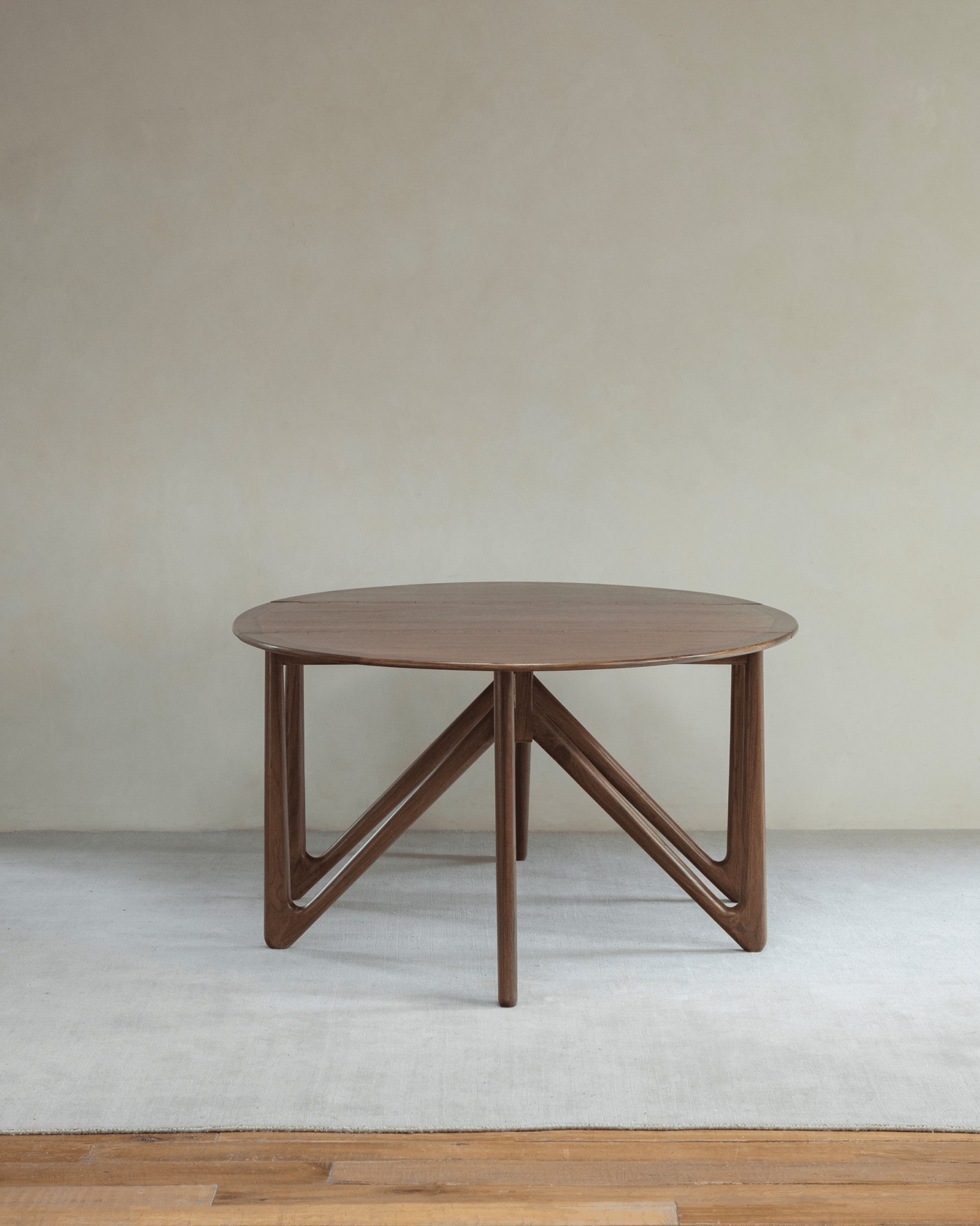 Niels Folding Table in Burmese teak wood, extended oval shape, V-shaped legs, mid-century modern design.