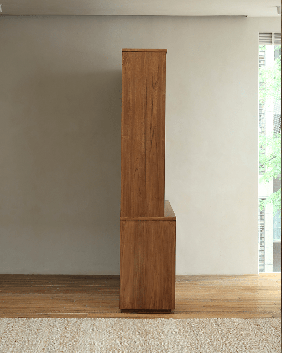 Teak wood glass front bookcase, side view showcasing the rich wood grain and elegant design, ideal for storage.