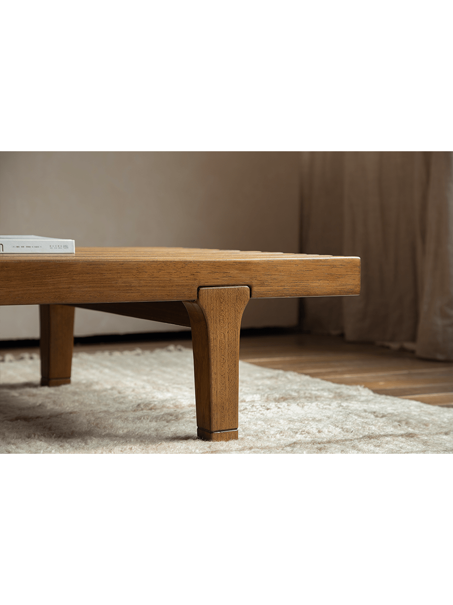 ZM Daybed Coffee Table close-up detail. Teak wood, minimalist design, tapered legs and slatted top, modern living room.