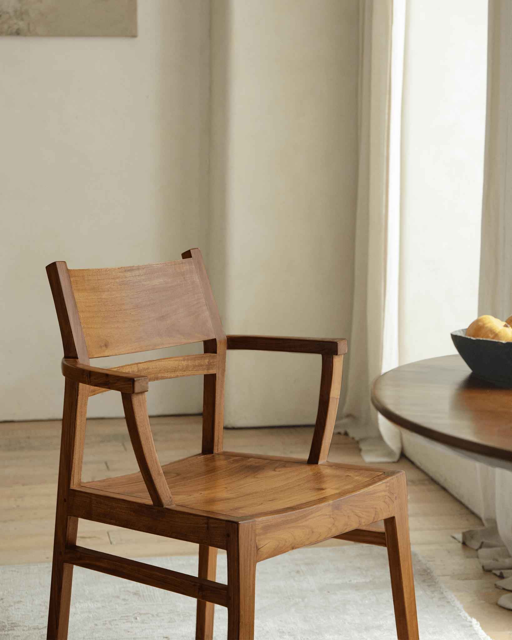 Wooden Hug Chair in a bright room, showcasing the warm wood tones and modern design