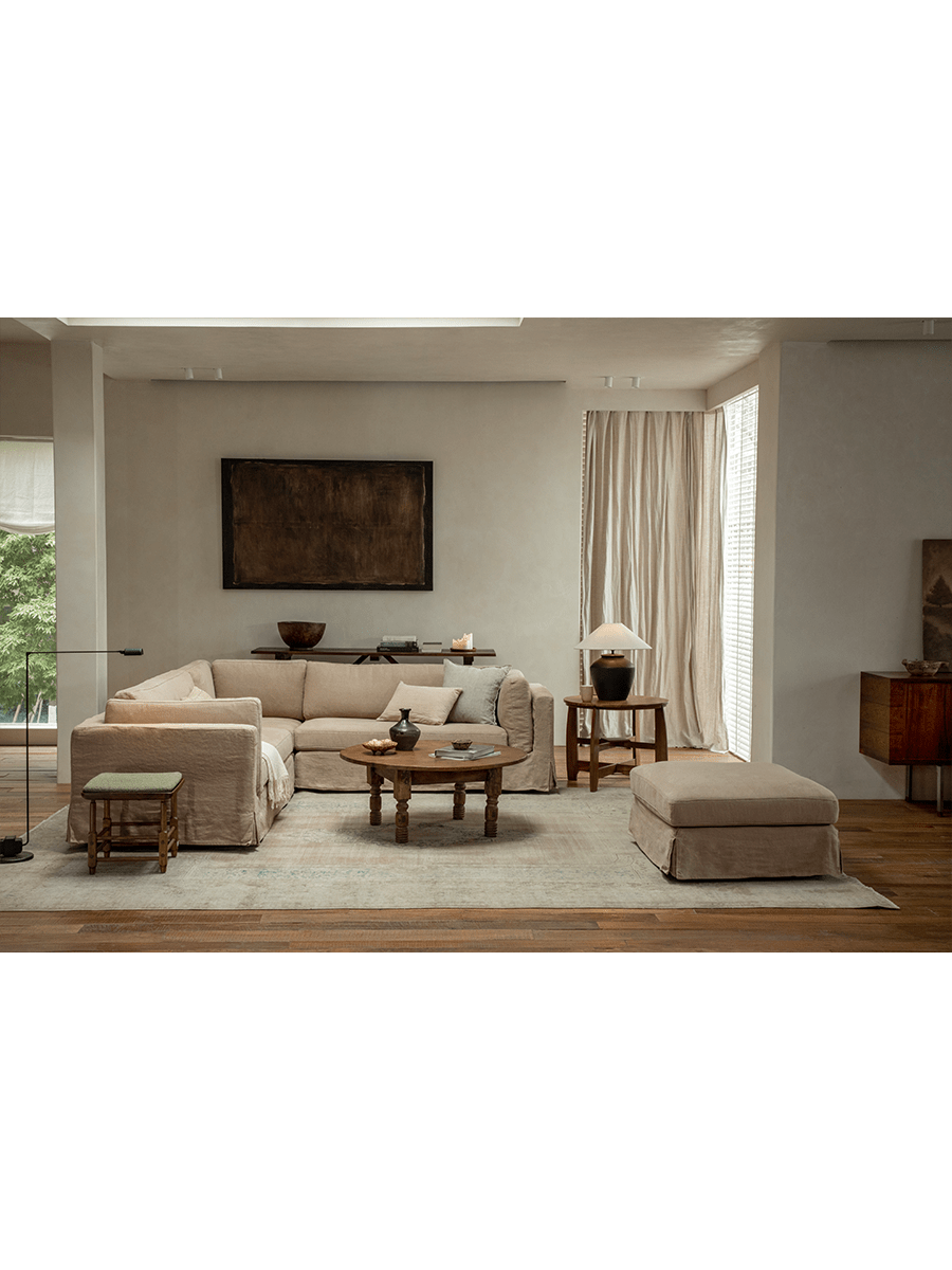 Beige linen Skirt Sectional Sofa in a modern living room, modular design, relaxed atmosphere, customizable comfort