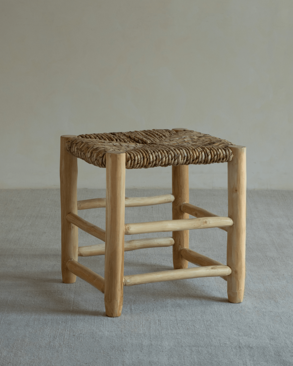 Isla Handwoven Stool with teak frame and pandan leaf seat. Natural, modern, and handcrafted for any space.