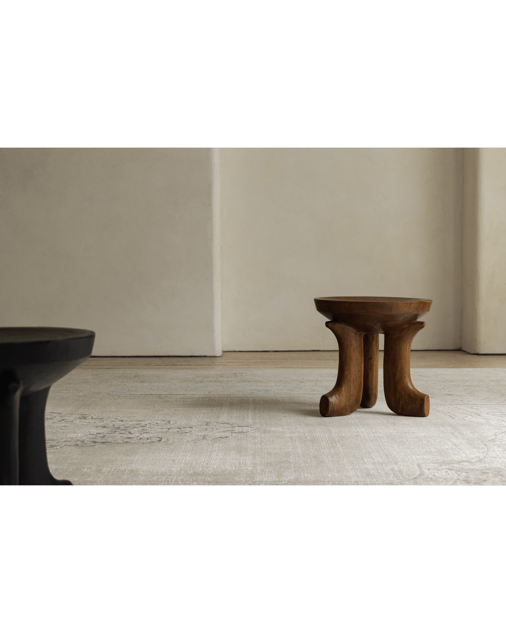 Quincy Stool, modern wood design, three legs, natural finish, in a cozy setting, home decor.