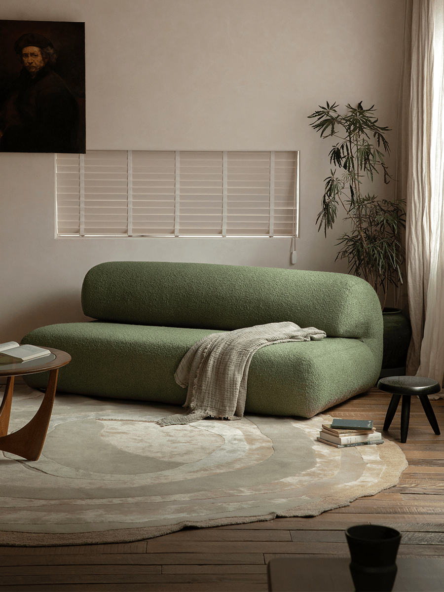 Green Wave Bouclé Sofa in a cozy, stylish living room. Soft bouclé fabric, wave design, and a comfortable interior setting.