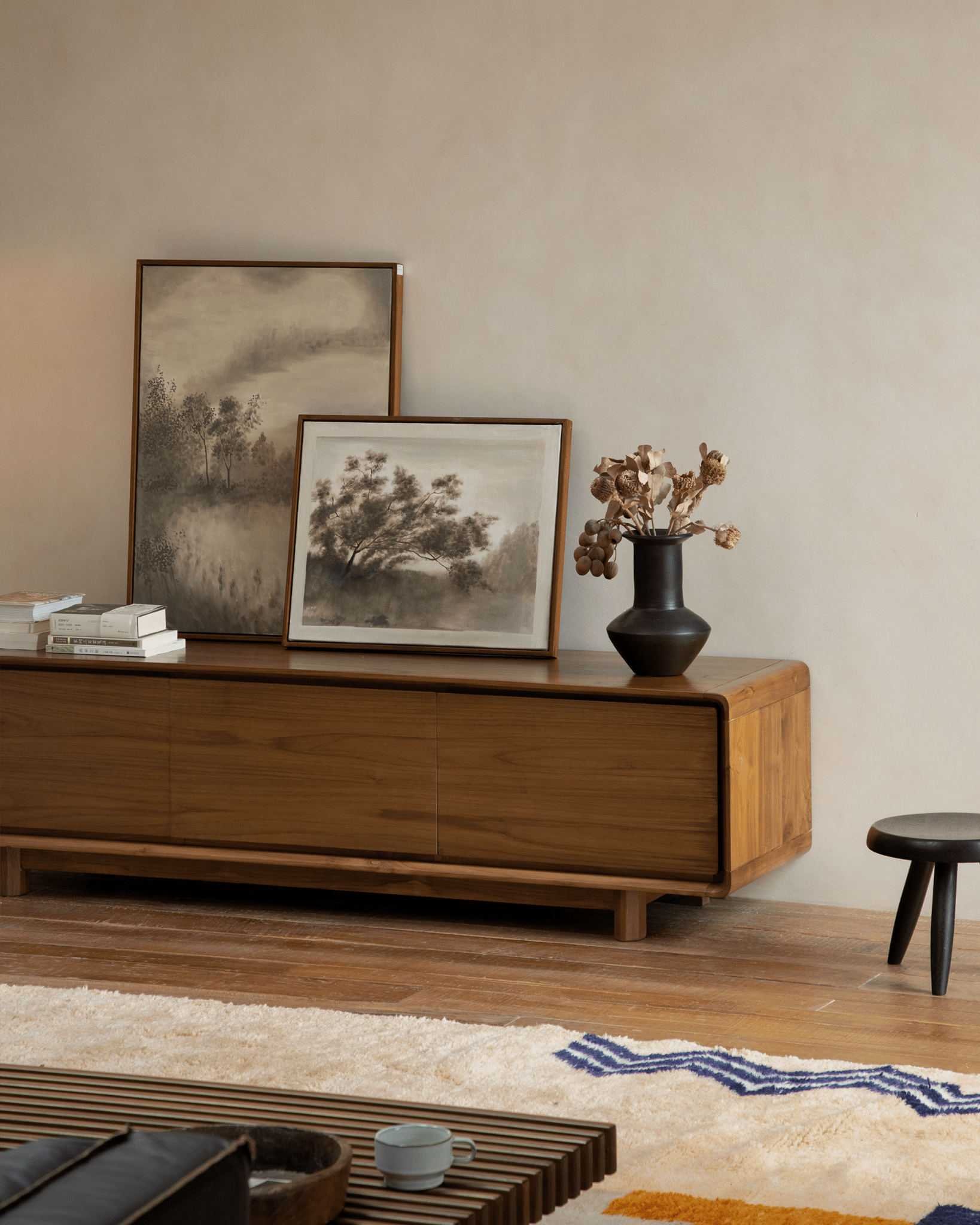 NO.34 Media Console in a living room setting with artwork, decorative items, and wooden furniture.