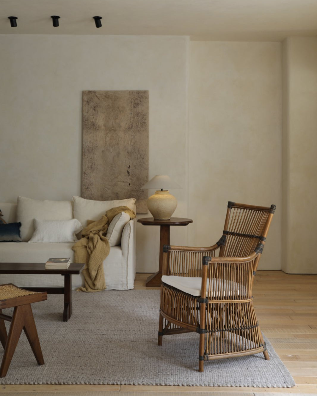 Da Vinci chair in living room setting, hand-woven rattan armchair with white cushion and natural materials