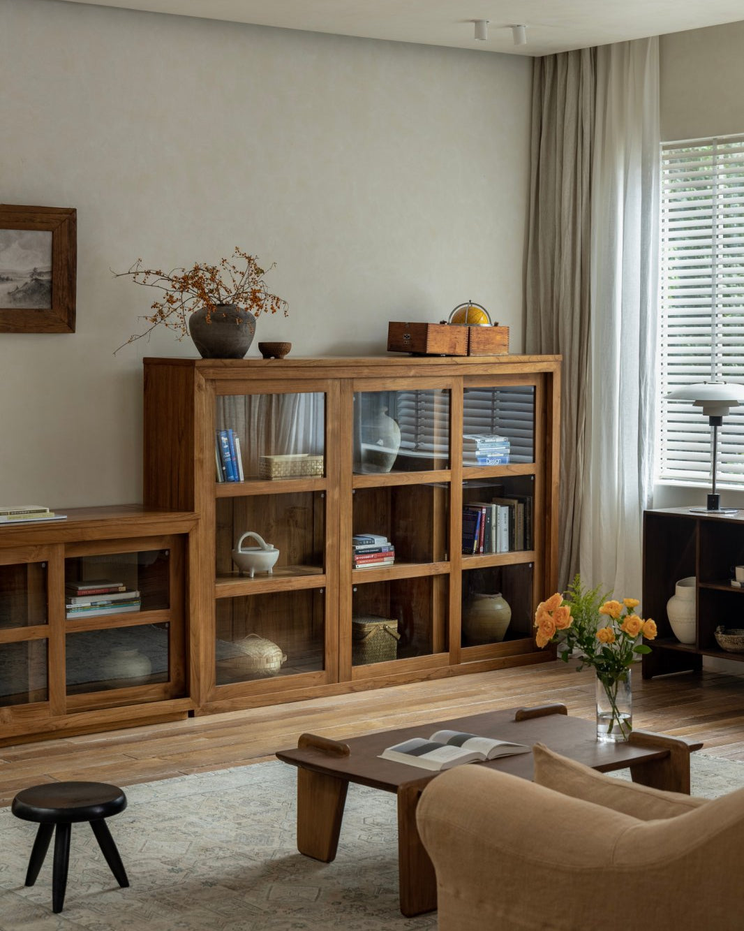 Teak wood glass front bookcase in stylish living room, perfect for display and storage