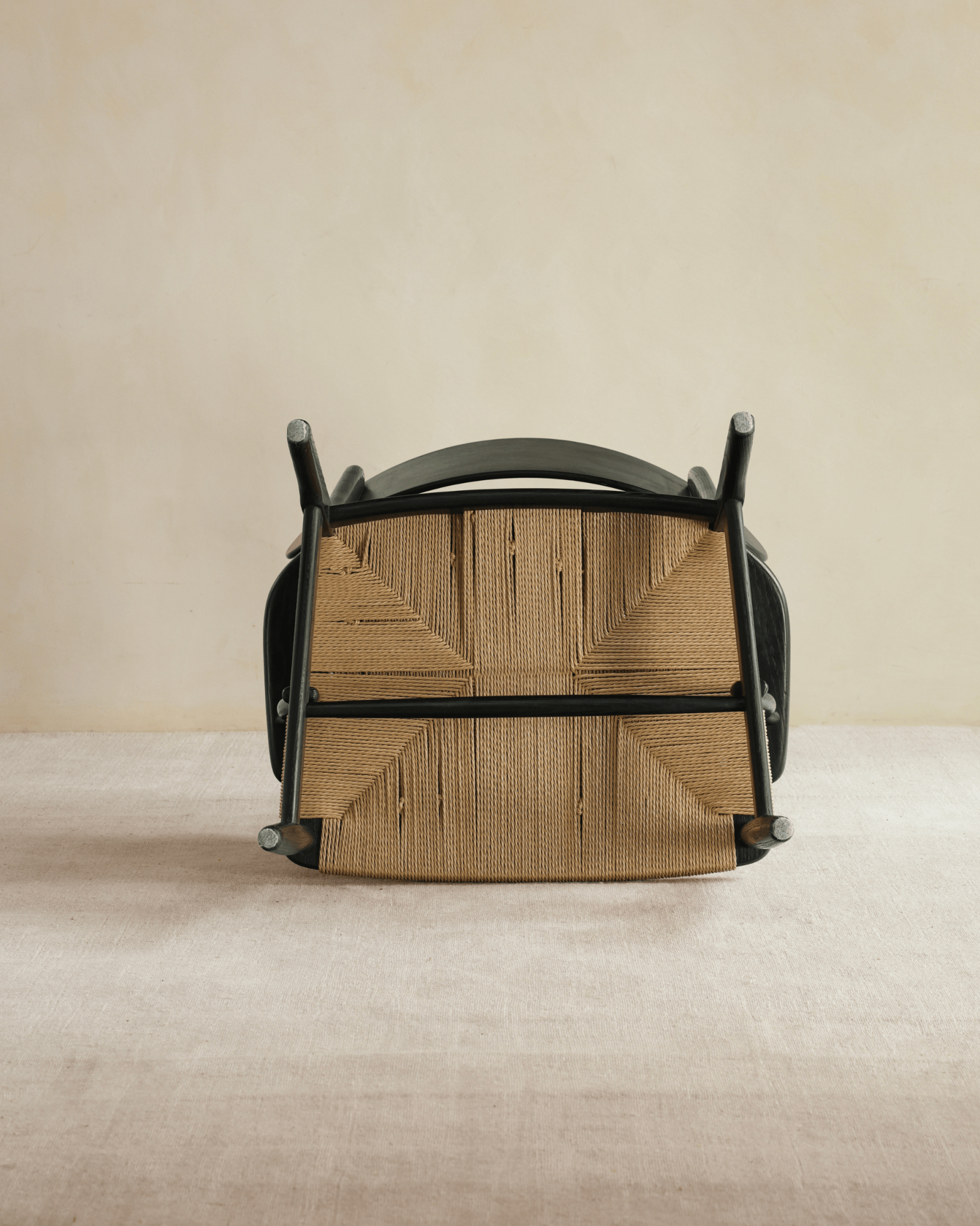 CH22 Lounge Chair upside down; black frame and paper cord seat, Scandinavian design