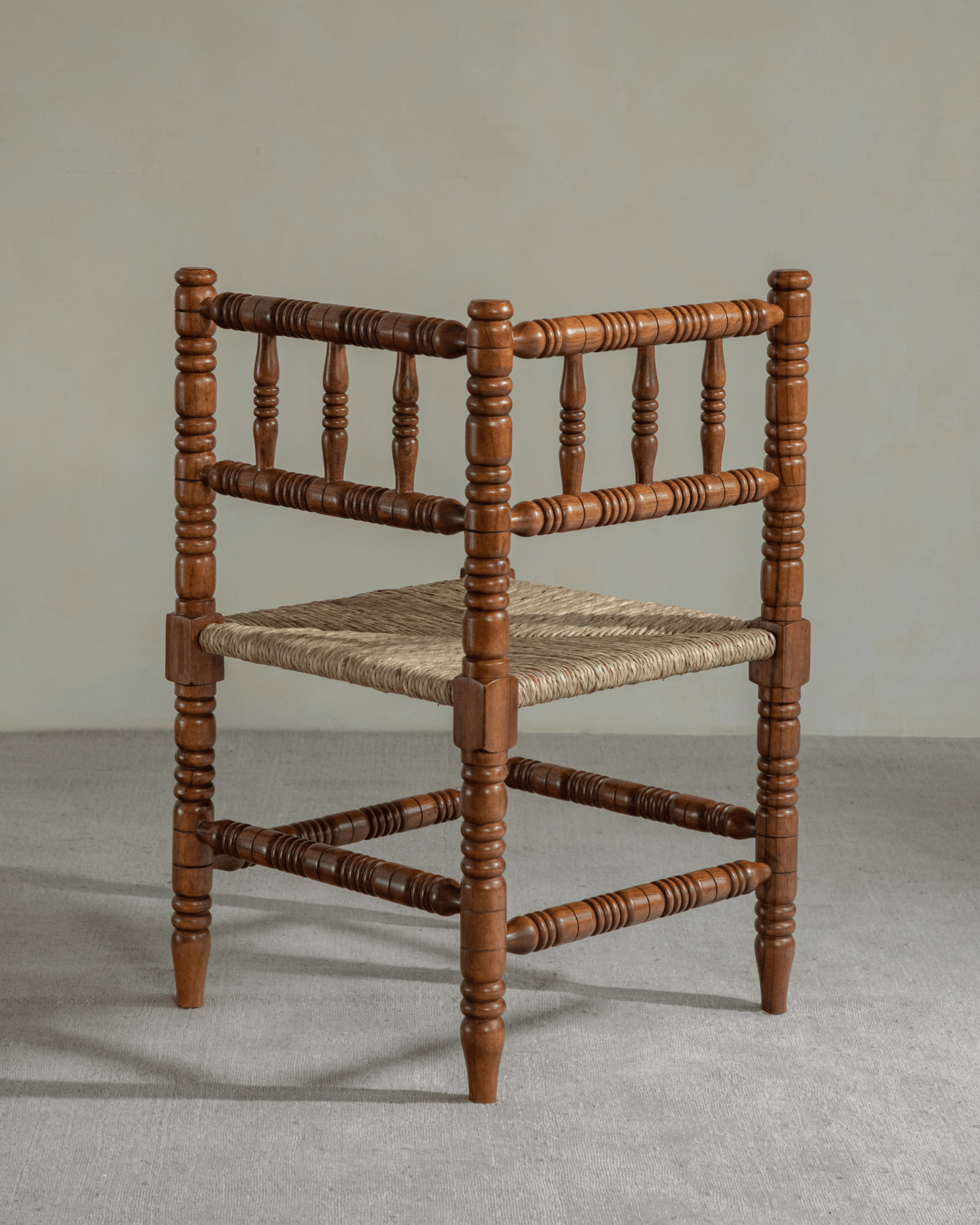 Bobbin Corner Chair - French vintage design, Indonesian Teak frame, grass rope seat, and handcrafted details.
