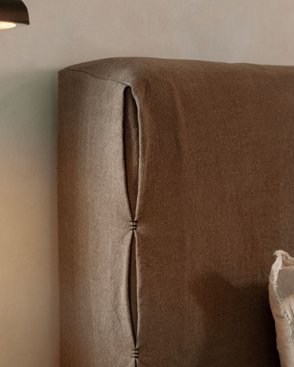 Freya Linen Bed headboard detail in terracotta linen with stitching, for peaceful sleep