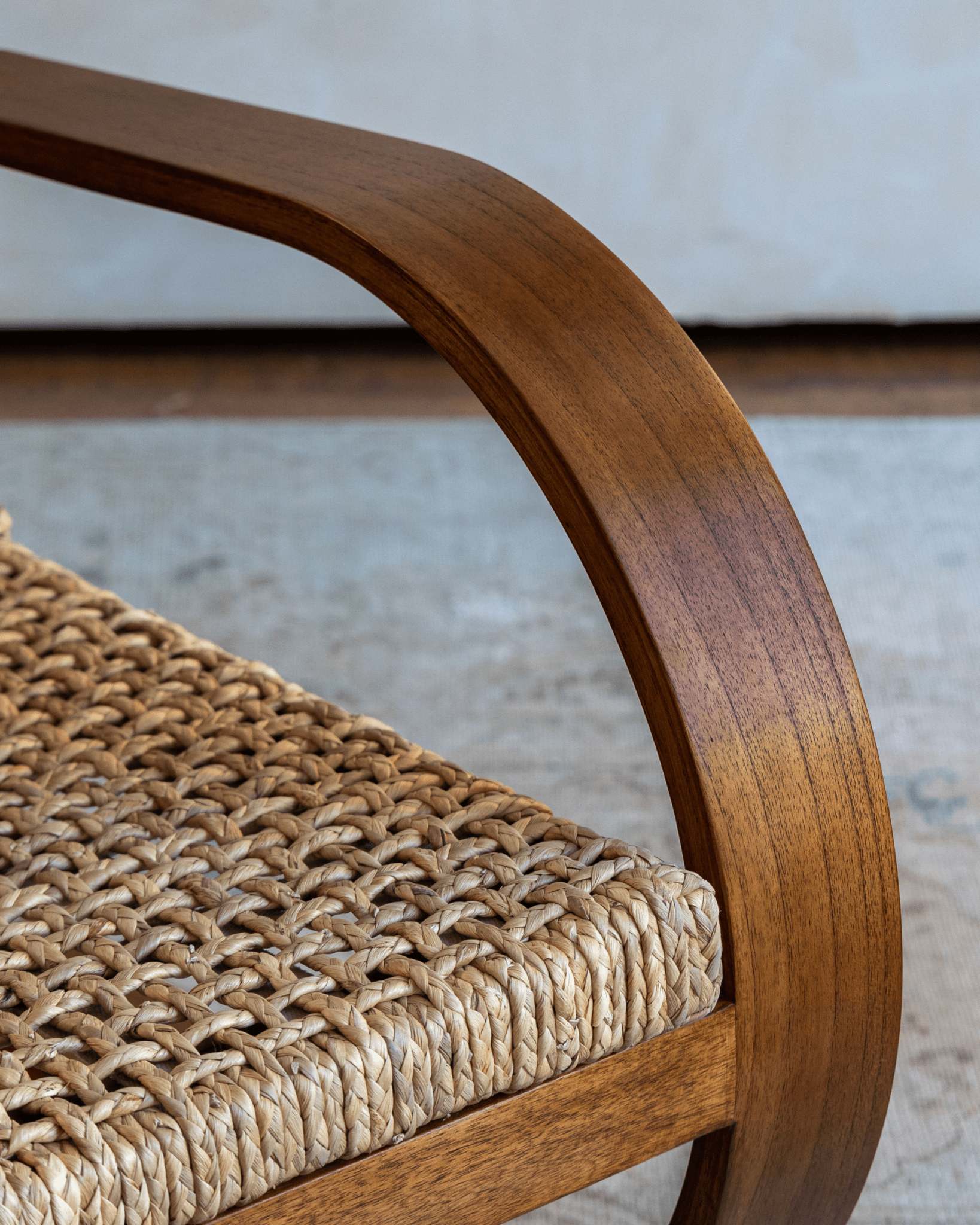 C Curve Lounge Chair detail: bentwood frame and woven grass rope seat, mid-century modern design.
