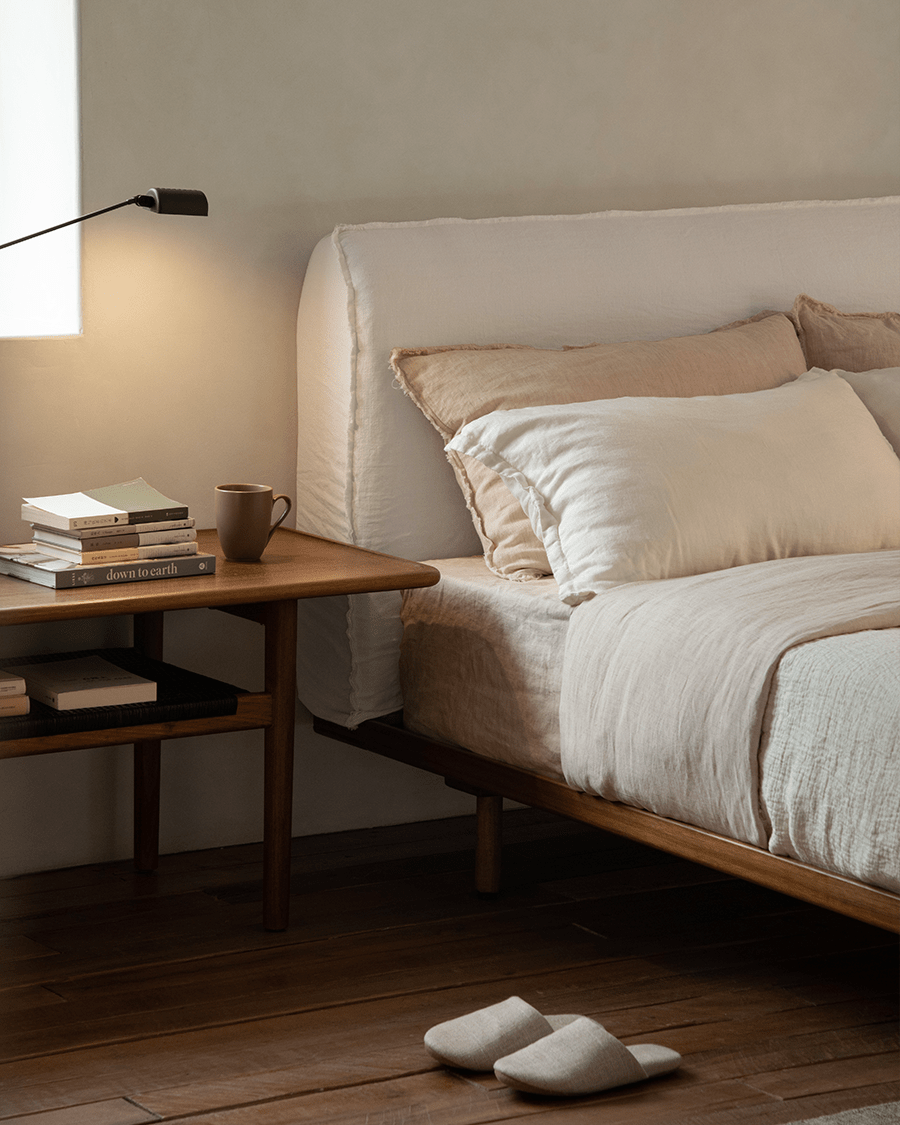 Seren Teak Linen Bed in a bedroom with natural linen bedding, solid teak frame, and down to earth side table