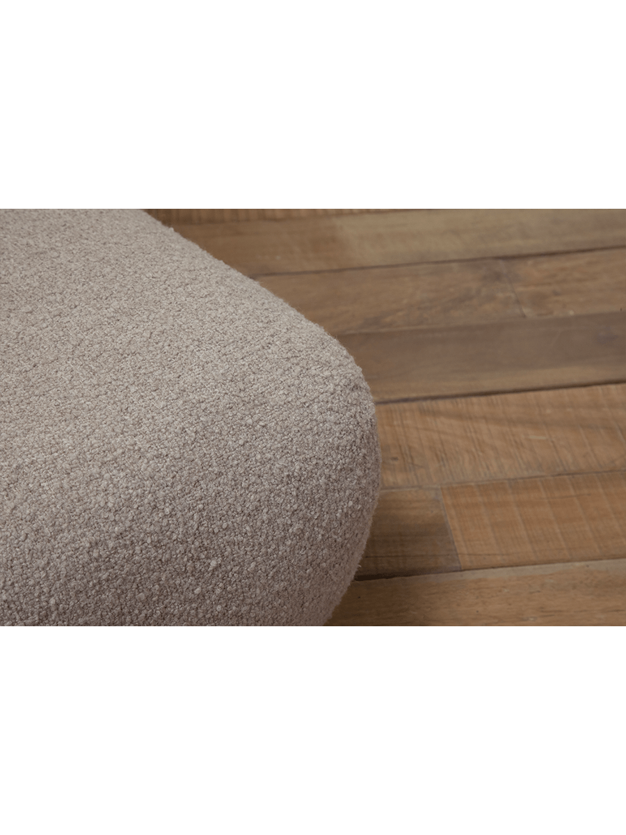 Close-up of beige Wave Bouclé Sofa fabric detail, soft bouclé texture, with wooden floor background