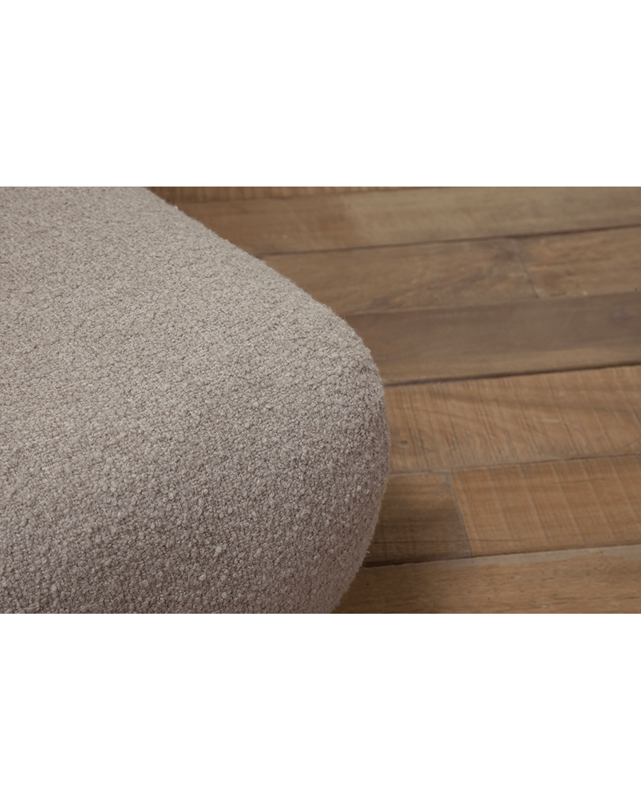 Close-up of beige Wave Bouclé Sofa fabric detail, soft bouclé texture, with wooden floor background