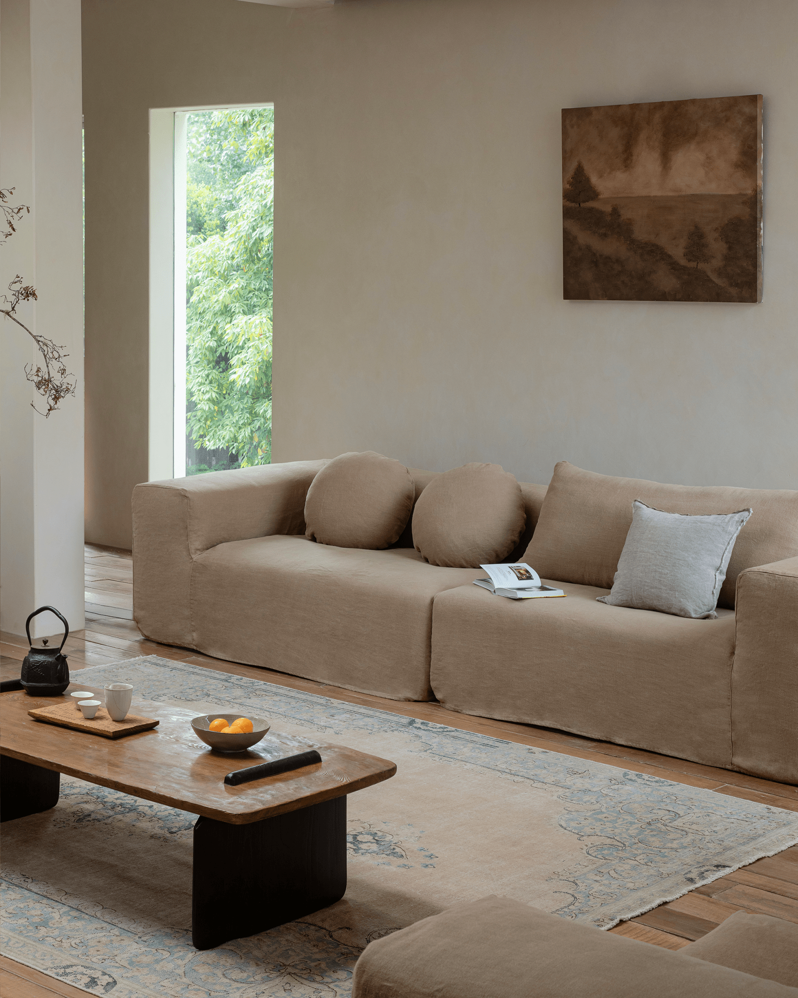 Doma sectional sofa with wide armrests in linen, bright living room. Relaxed, modular design.