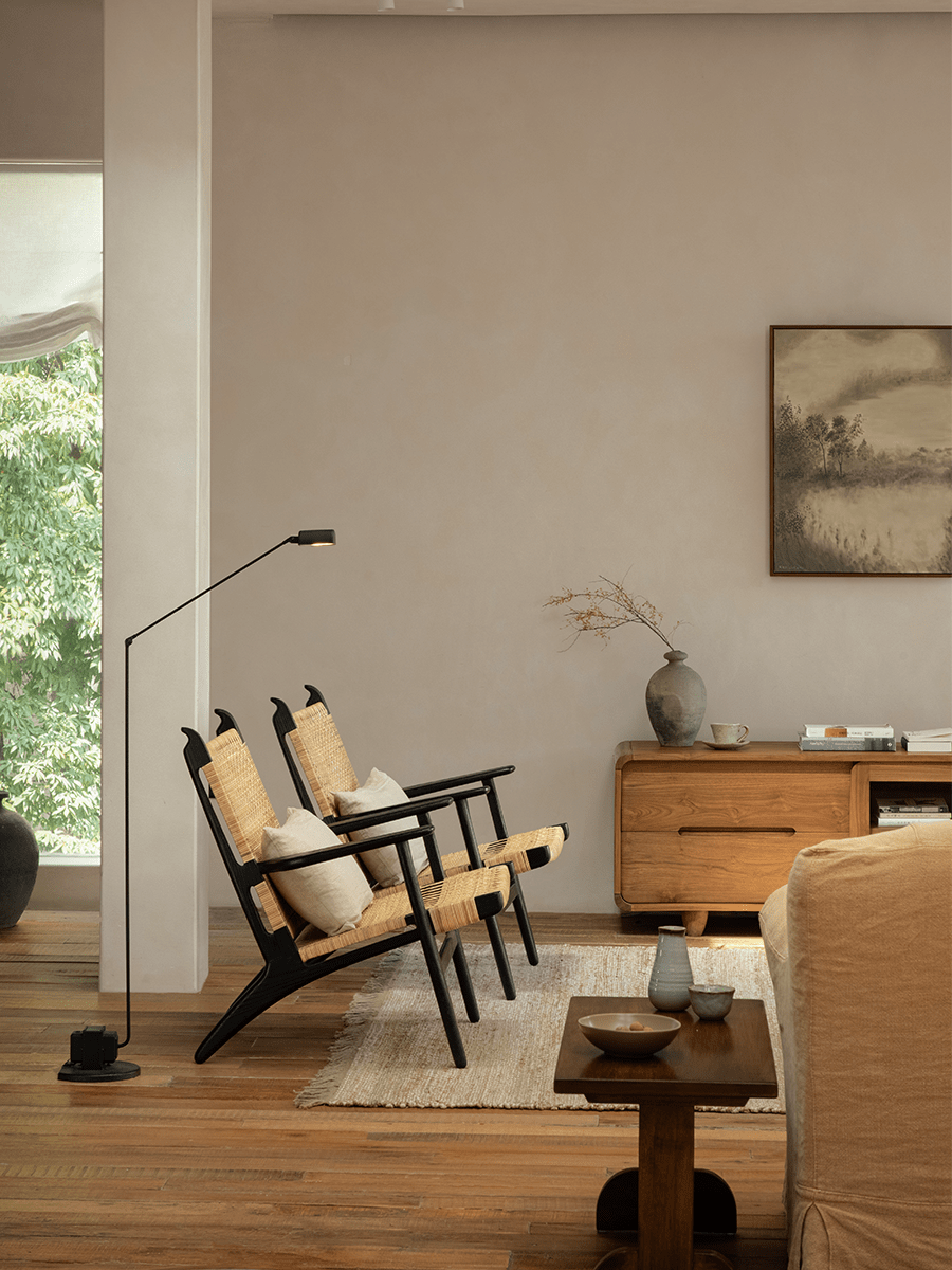 Horn Lounge Chairs in a cozy interior, with black oak frame and natural rattan, ergonomic design, perfect for interior decor.