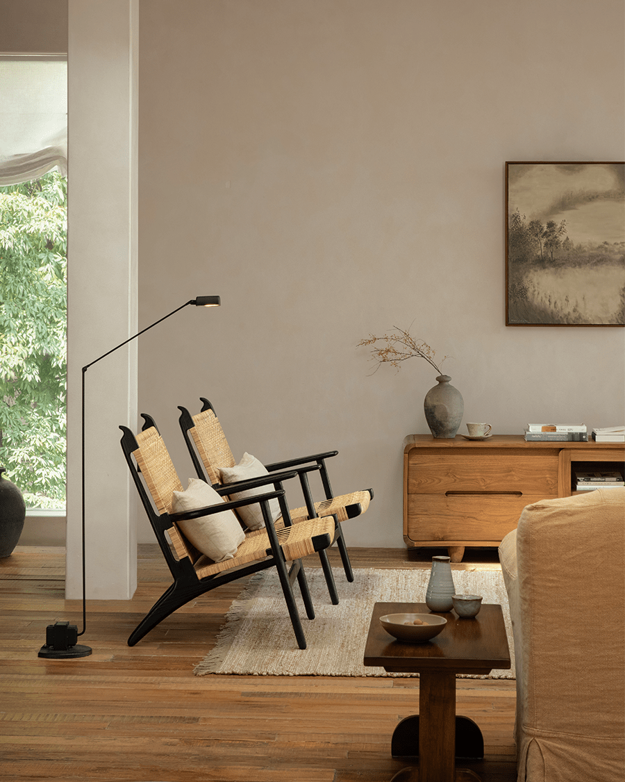 Horn Lounge Chairs in a cozy interior, with black oak frame and natural rattan, ergonomic design, perfect for interior decor.