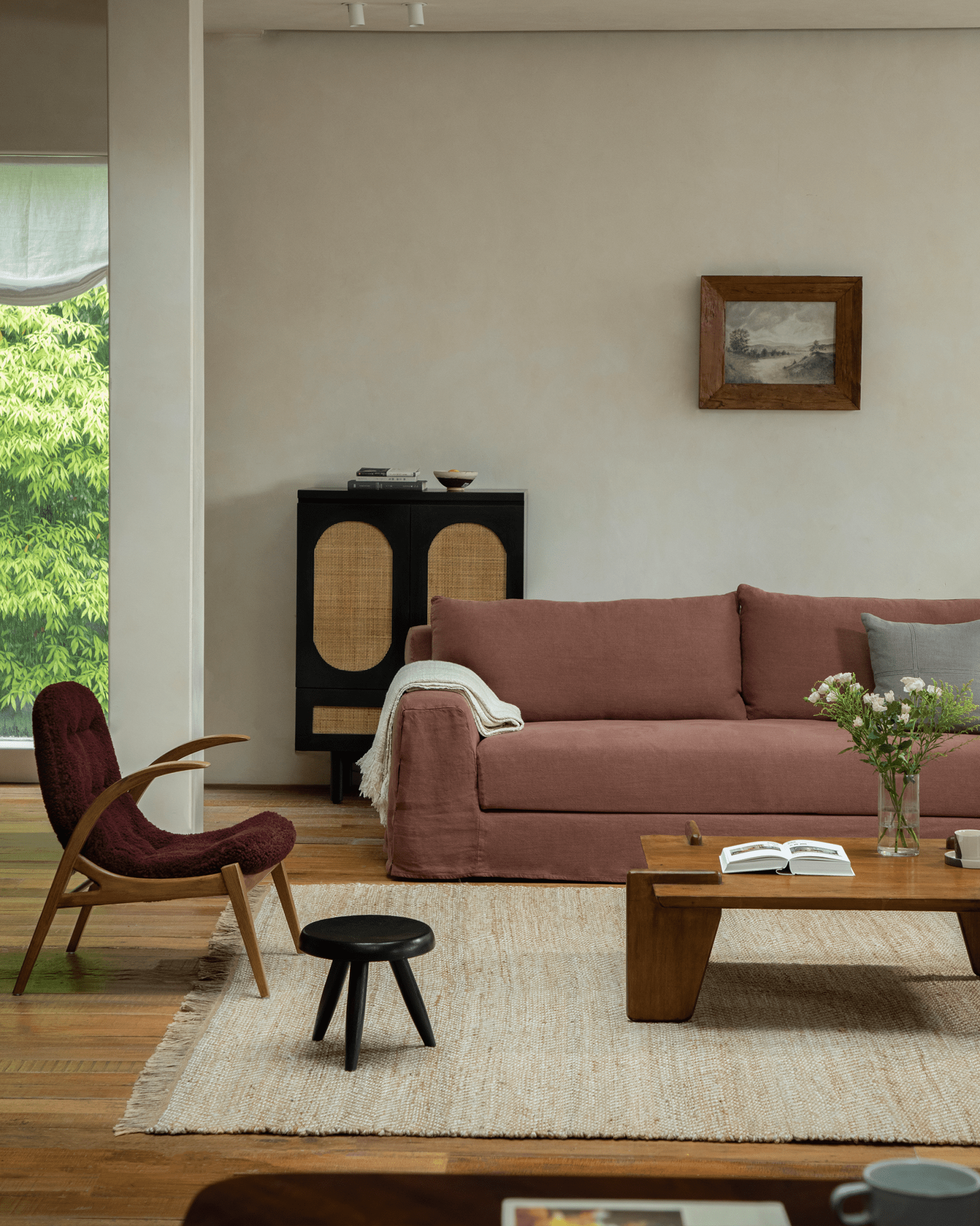 Guni terracotta linen sofa in a cozy living room setting with wooden furniture and natural textures
