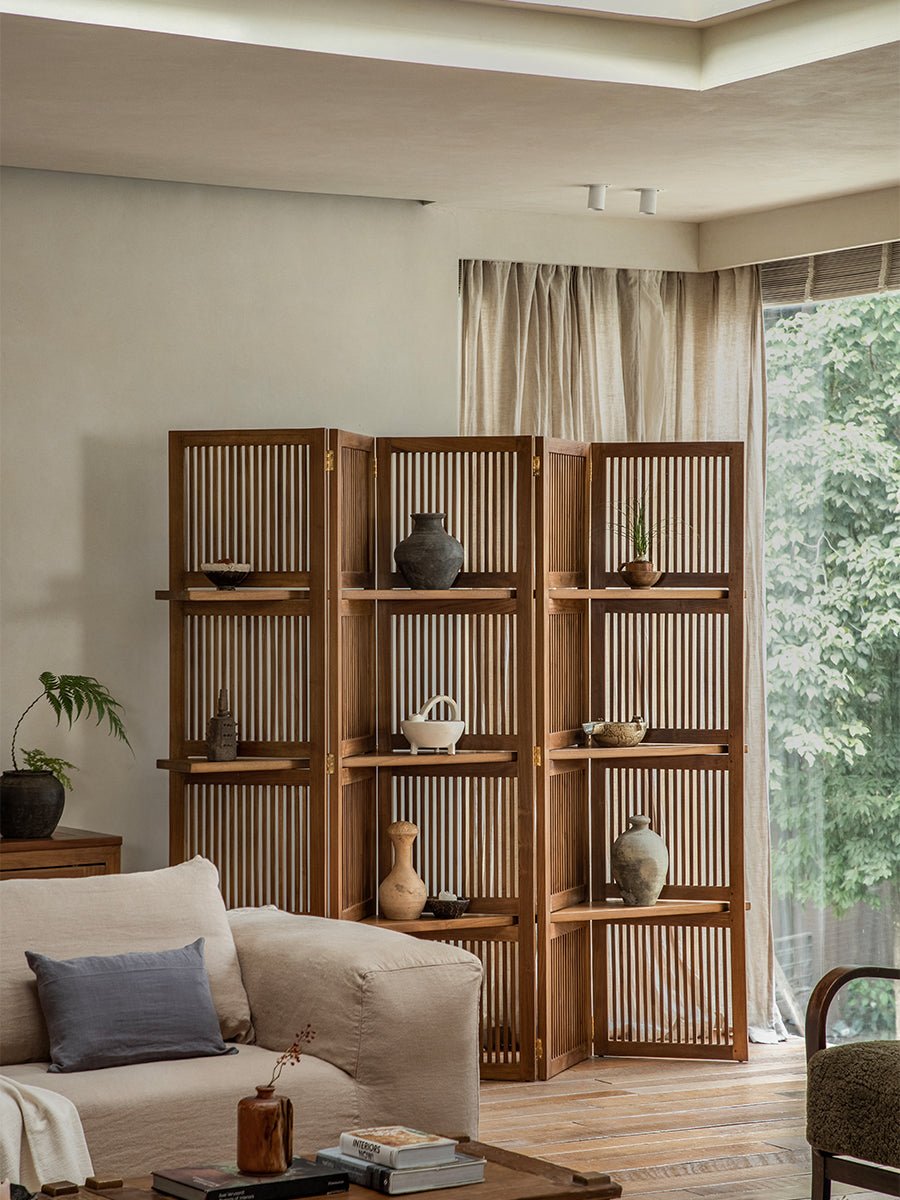 Sylvan teak room divider with slatted panels, displaying decorative items in a living room.