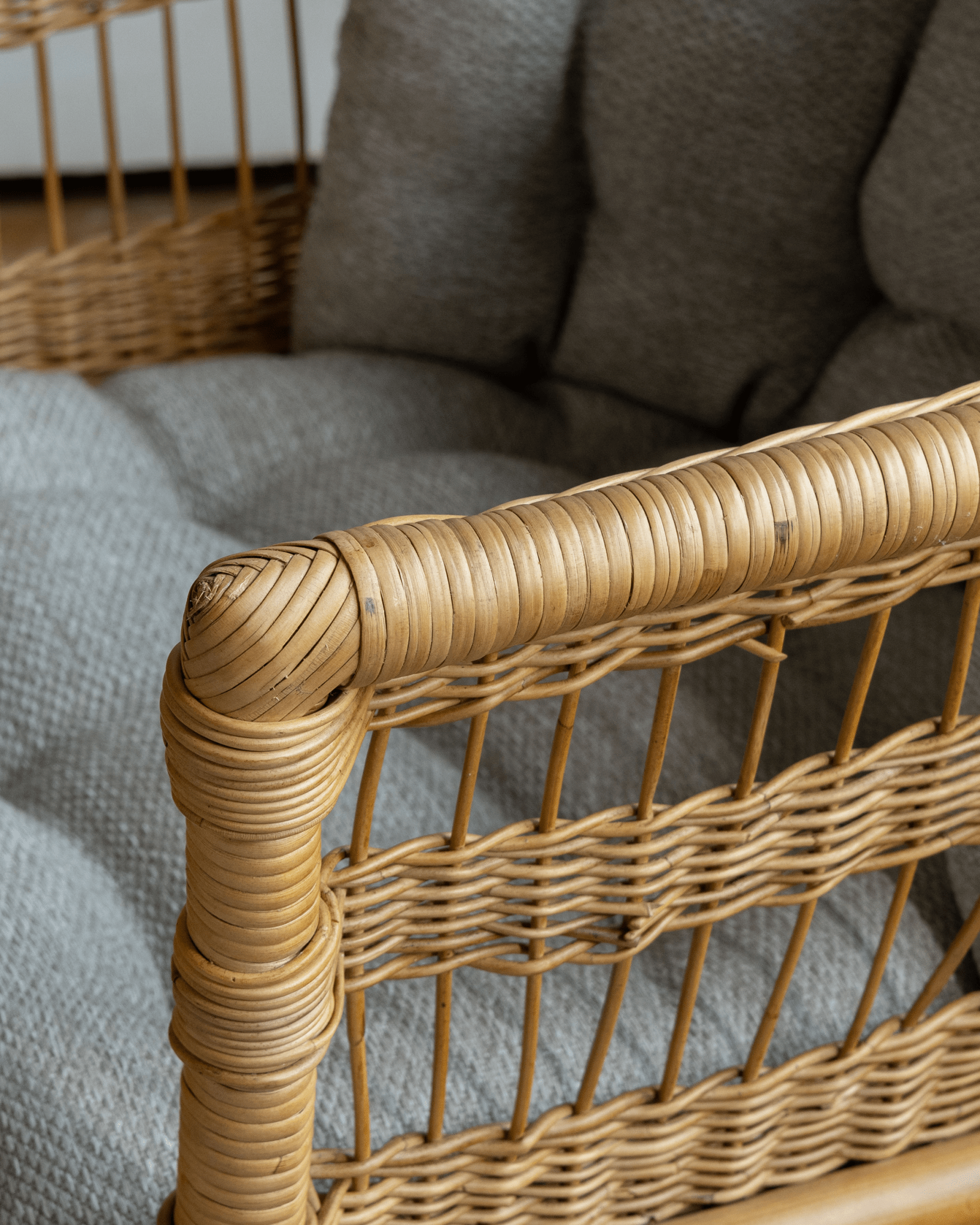Helian Rattan Chair detail: natural rattan frame, gray silk cushion, woven design