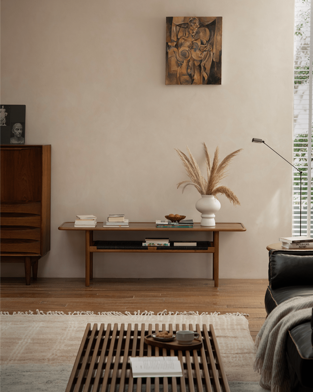 Hans Accent Table styled in a modern living room with minimalist decor and a warm color palette.