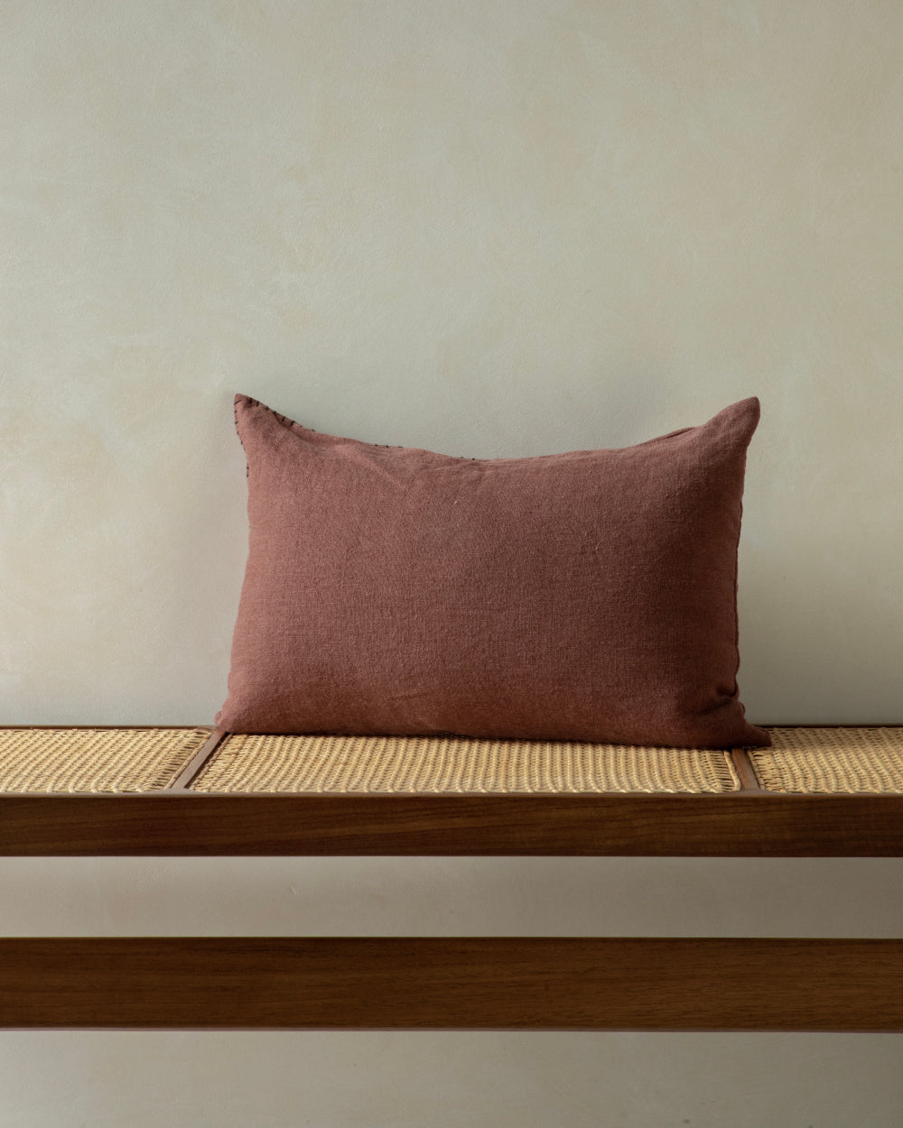 Linora Pillow in terracotta yarn-dyed linen with hand-stitched detail.