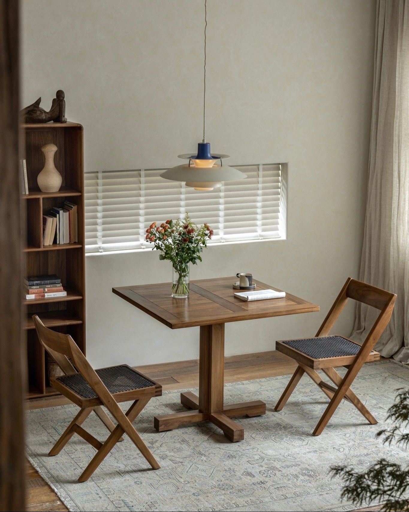 Felix Square Teak Table in dining room setting with wooden chairs, perfect for dining