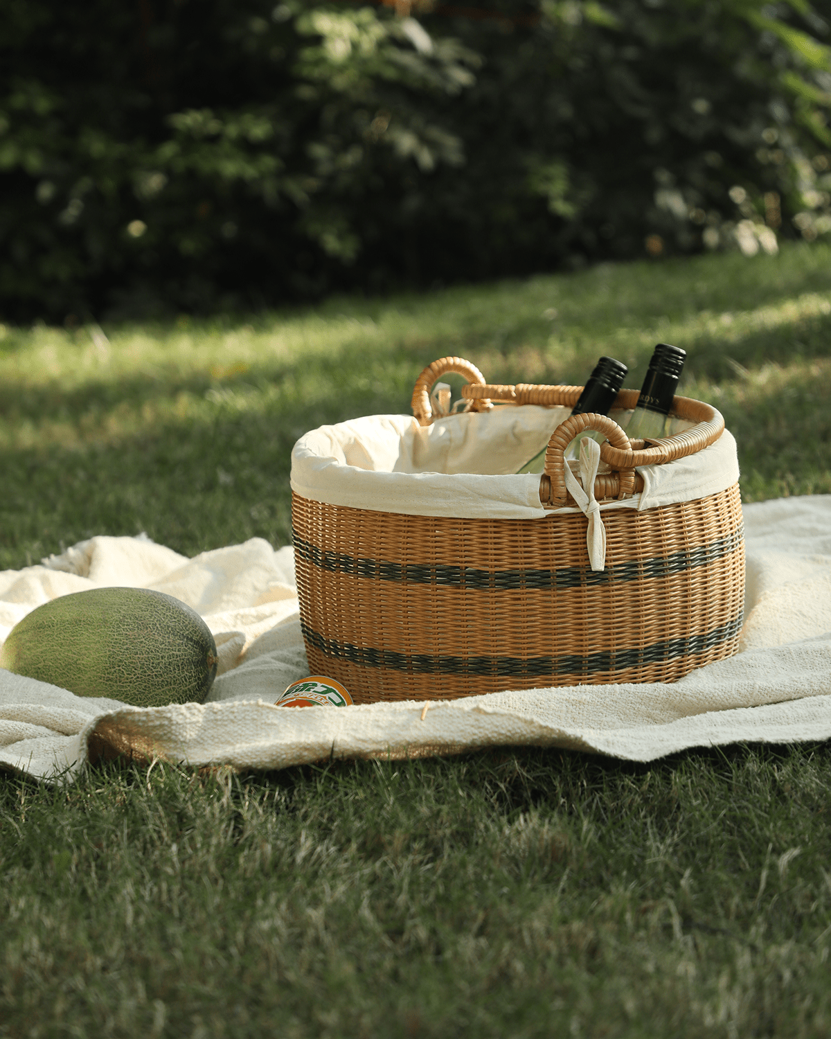 Sunday picnic bucket: Handwoven rattan basket with cotton lining and two bottles.