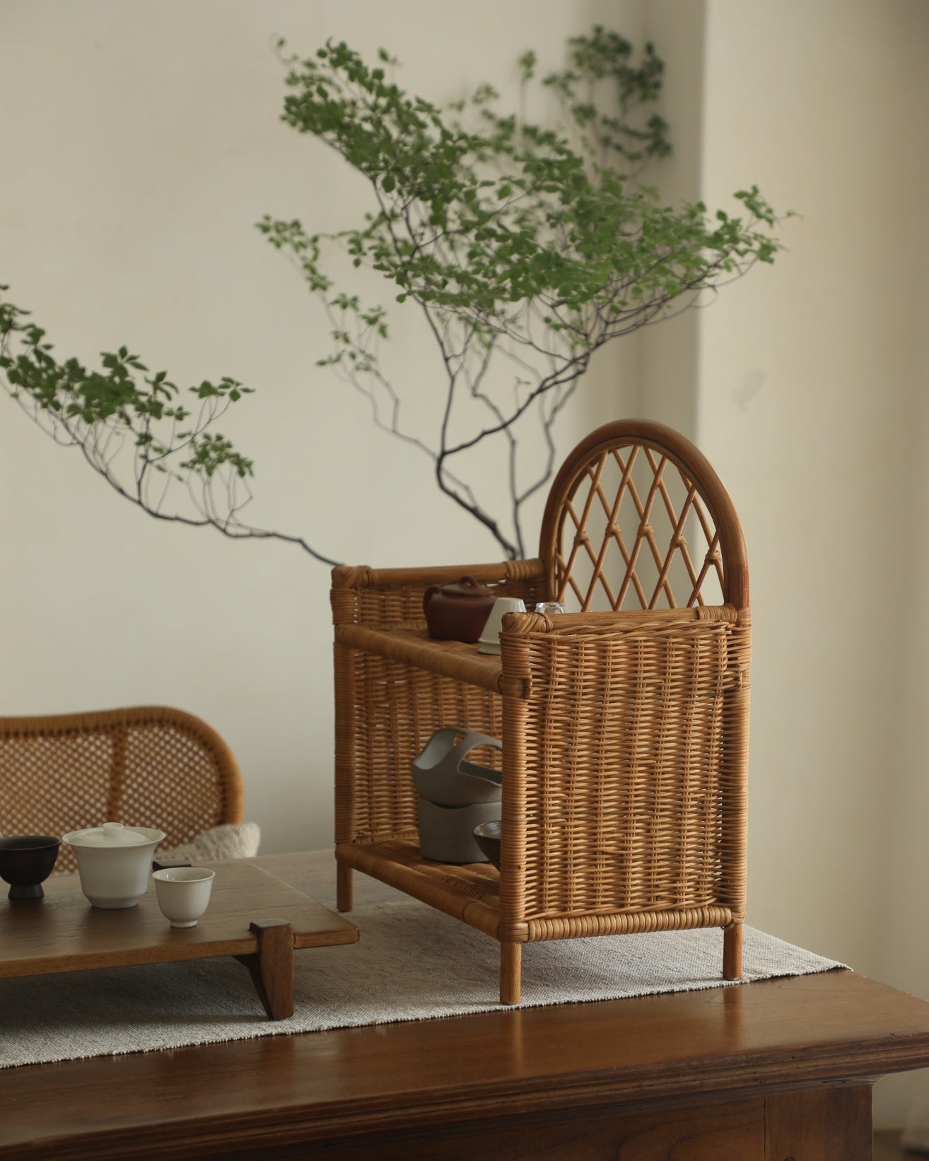 Woven rattan Solana Stand with arched back and two open shelves.