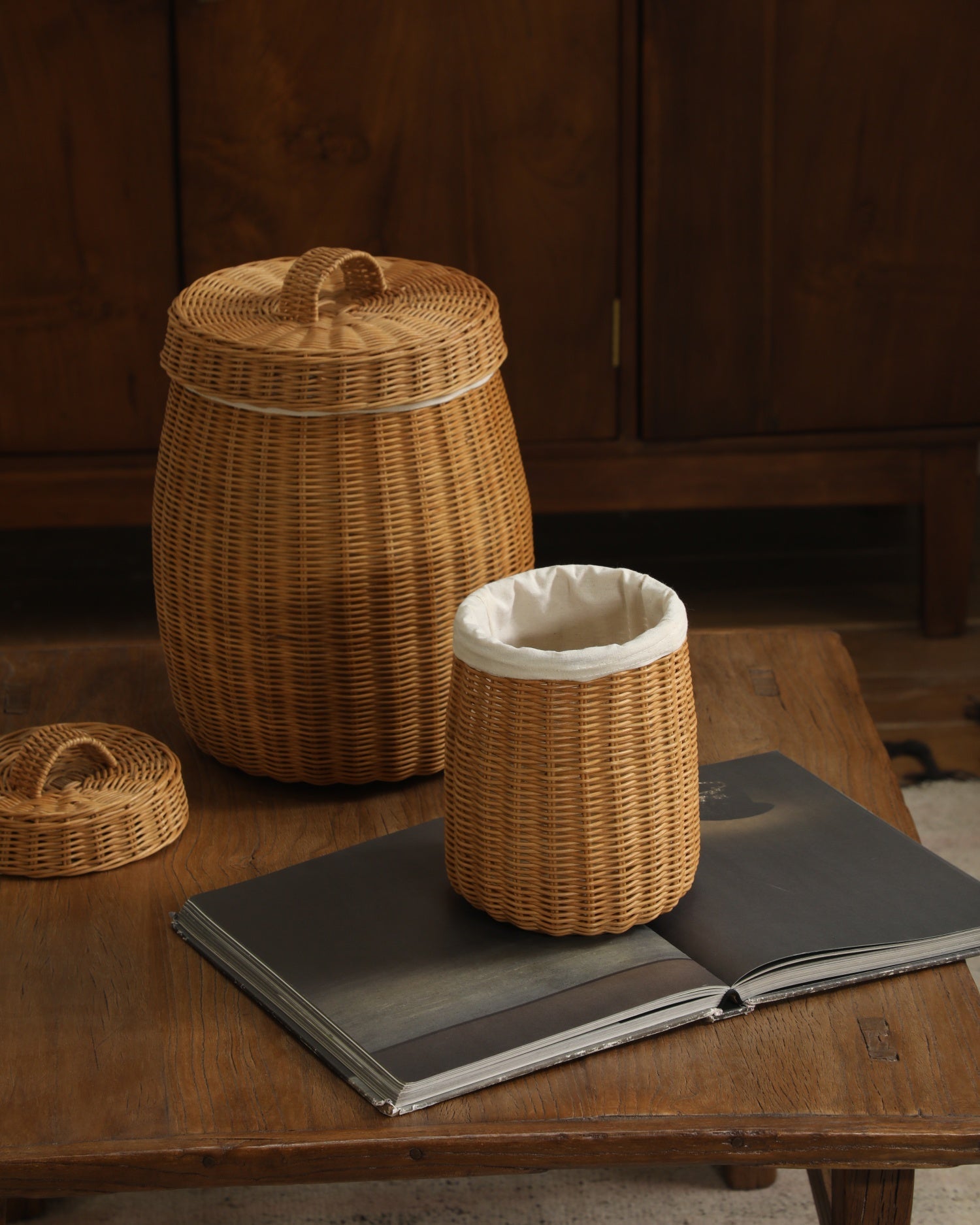Natural rattan Elodie Round Storage Basket with lid and white cotton lining, rustic texture.