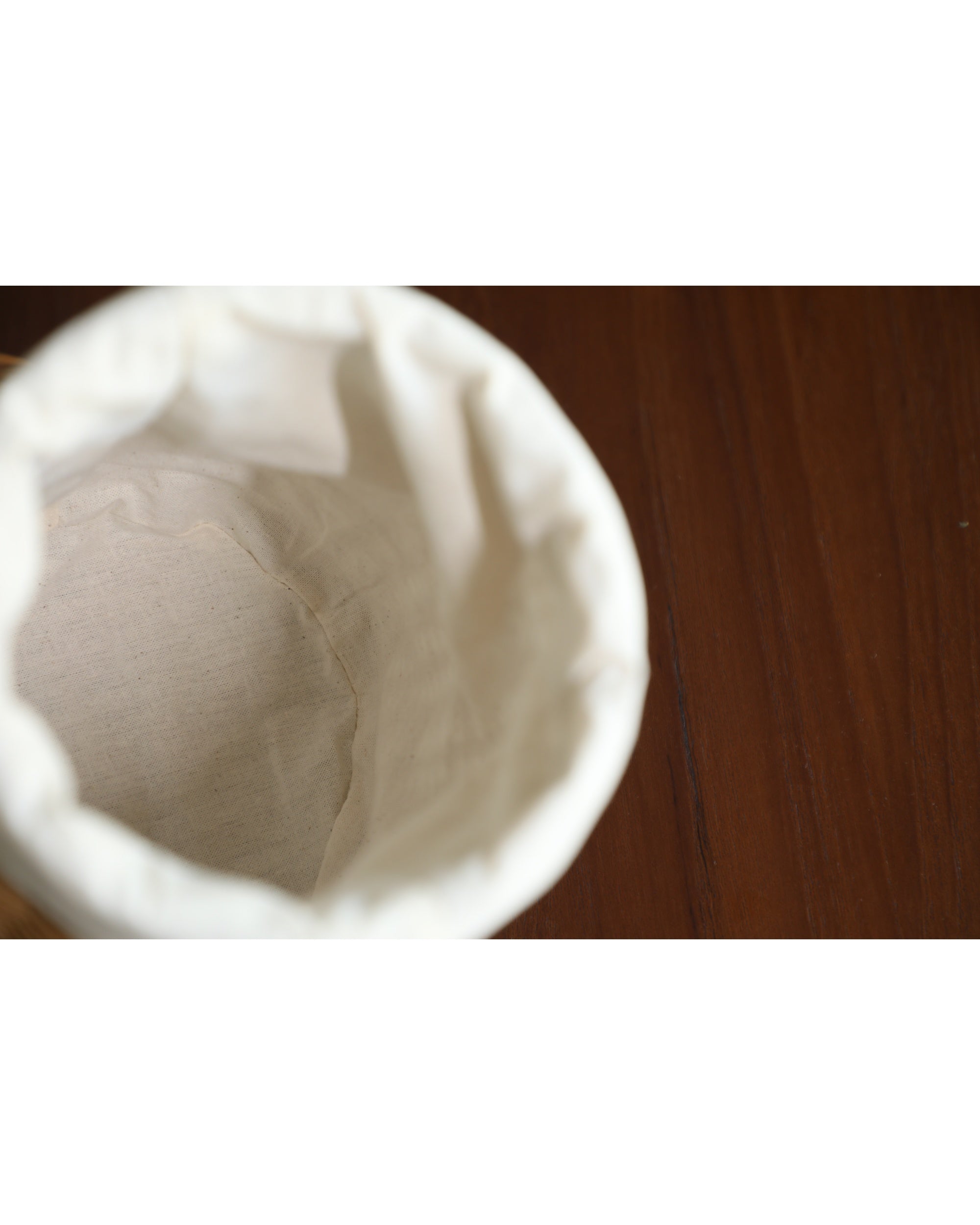 Elodie Round Storage Basket interior with natural cotton lining and rattan detail.