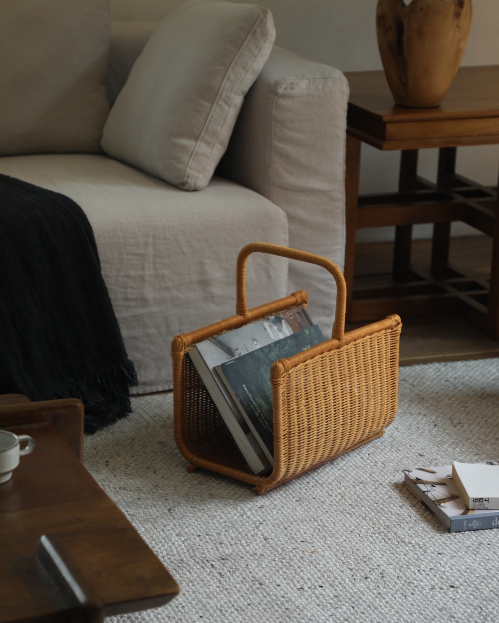 Folio Caddy woven book basket with integrated handle and textured weave.