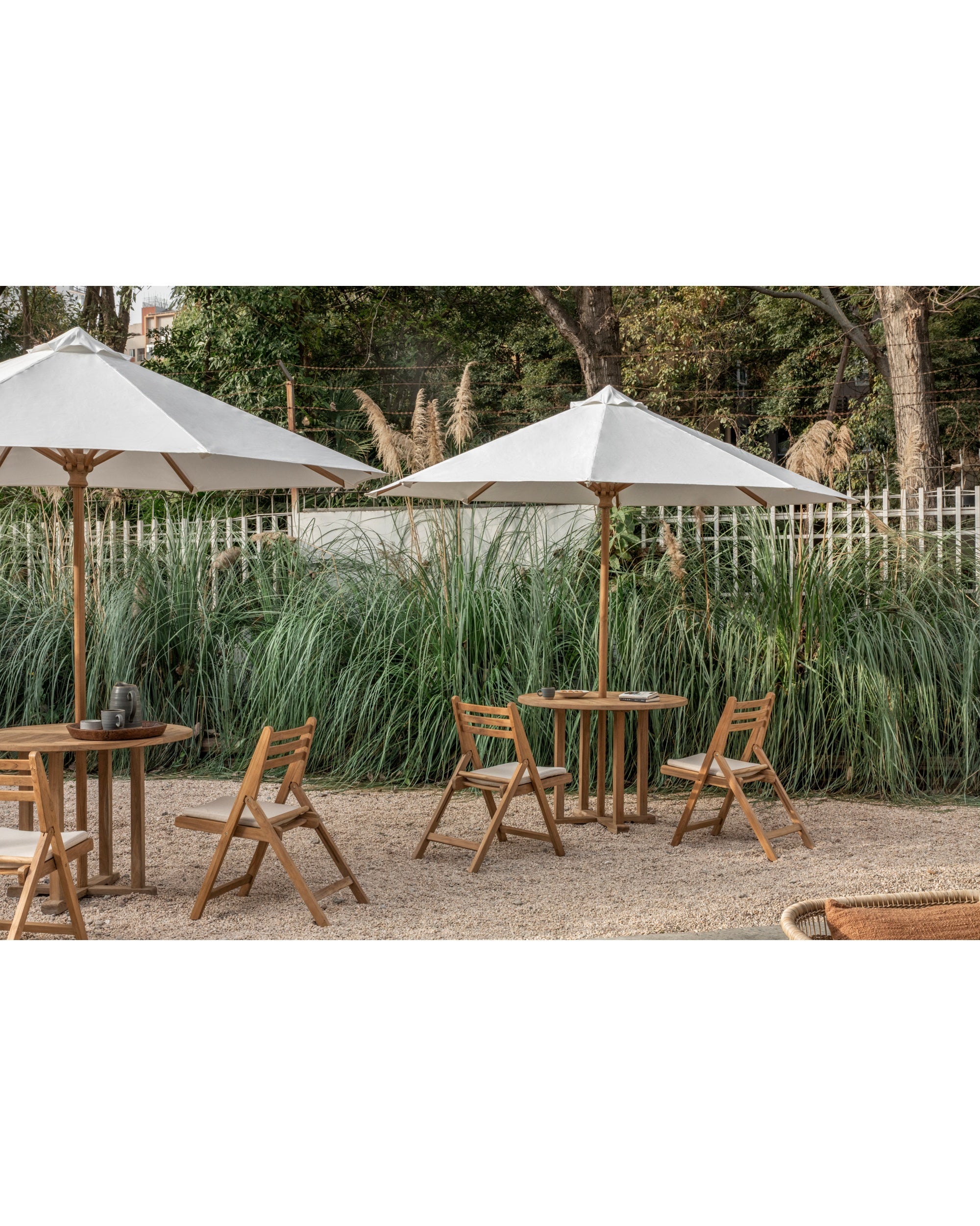 Durable teak outdoor patio table and umbrella set with white canopy