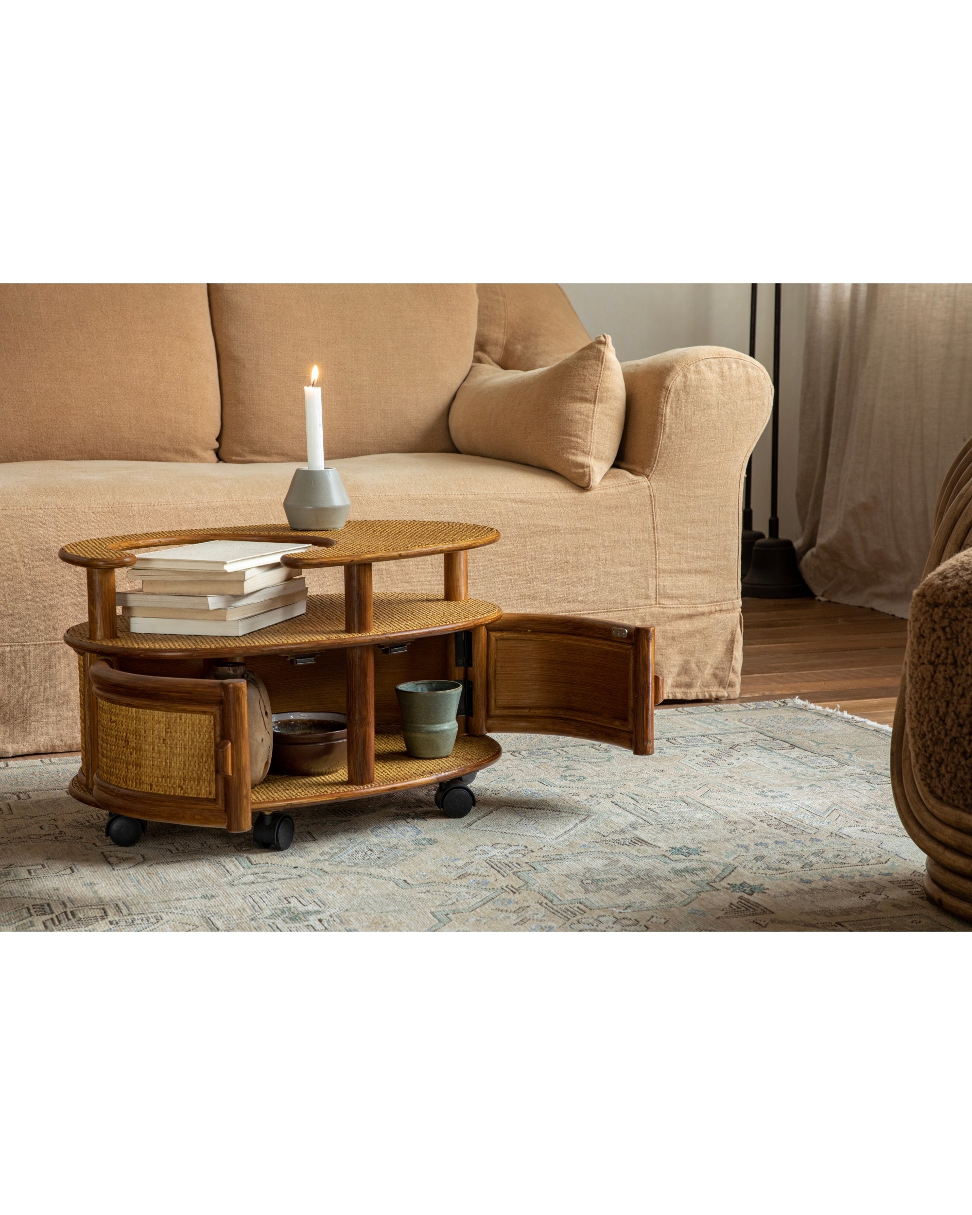Noa Rattan Wheeled Table: Natural woven rattan, dual-tier, with storage cabinet and casters.