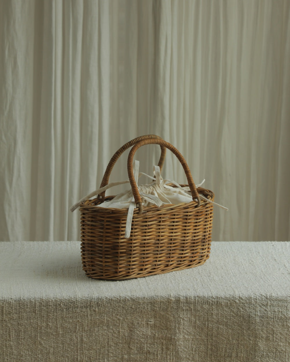 Ann Rattan Handbag: natural woven rattan, twin handles, cream lining.