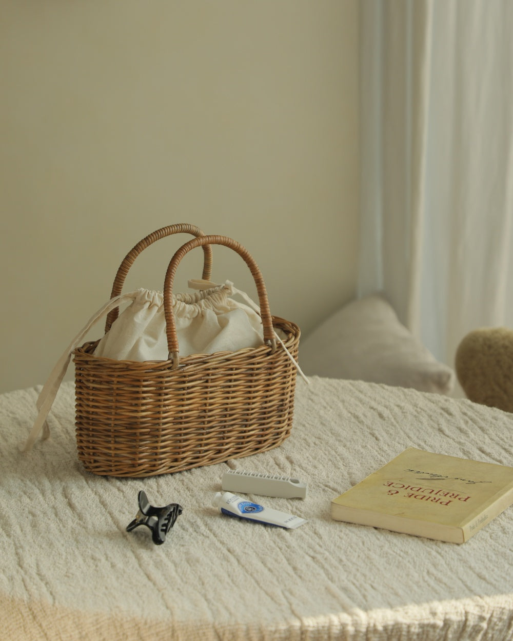 Ann rattan handbag with dual handles and cream drawstring lining