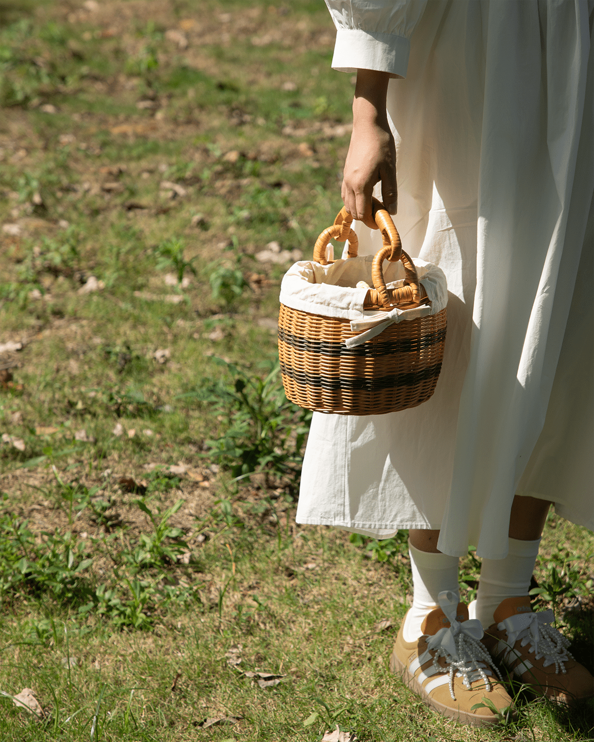 Sunday Picnic Bucket: handwoven rattan basket with striped body and white cotton lining.