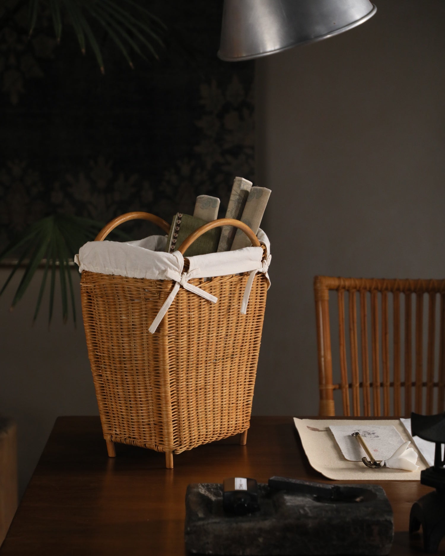 Luna storage basket: woven rattan with literary charm, lined with cotton, holding books.