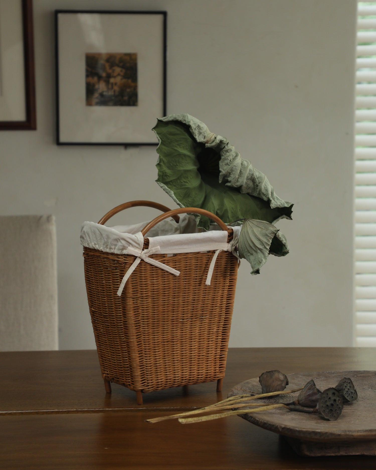 Luna woven rattan storage basket with tapered design and literary charm.