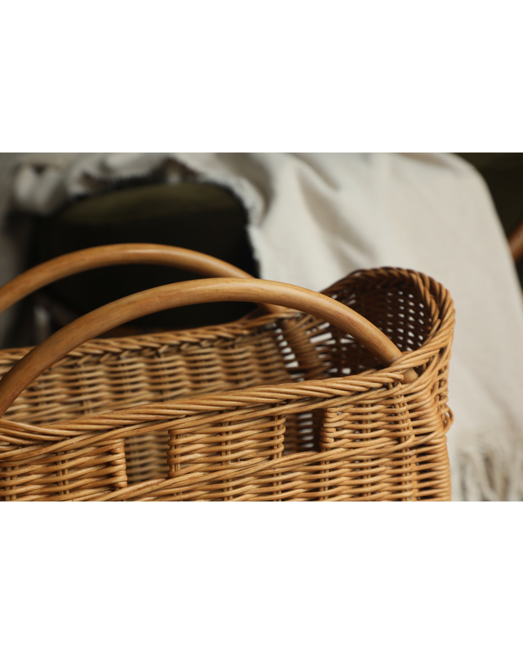 Woven rattan Luna storage basket with wooden handles.