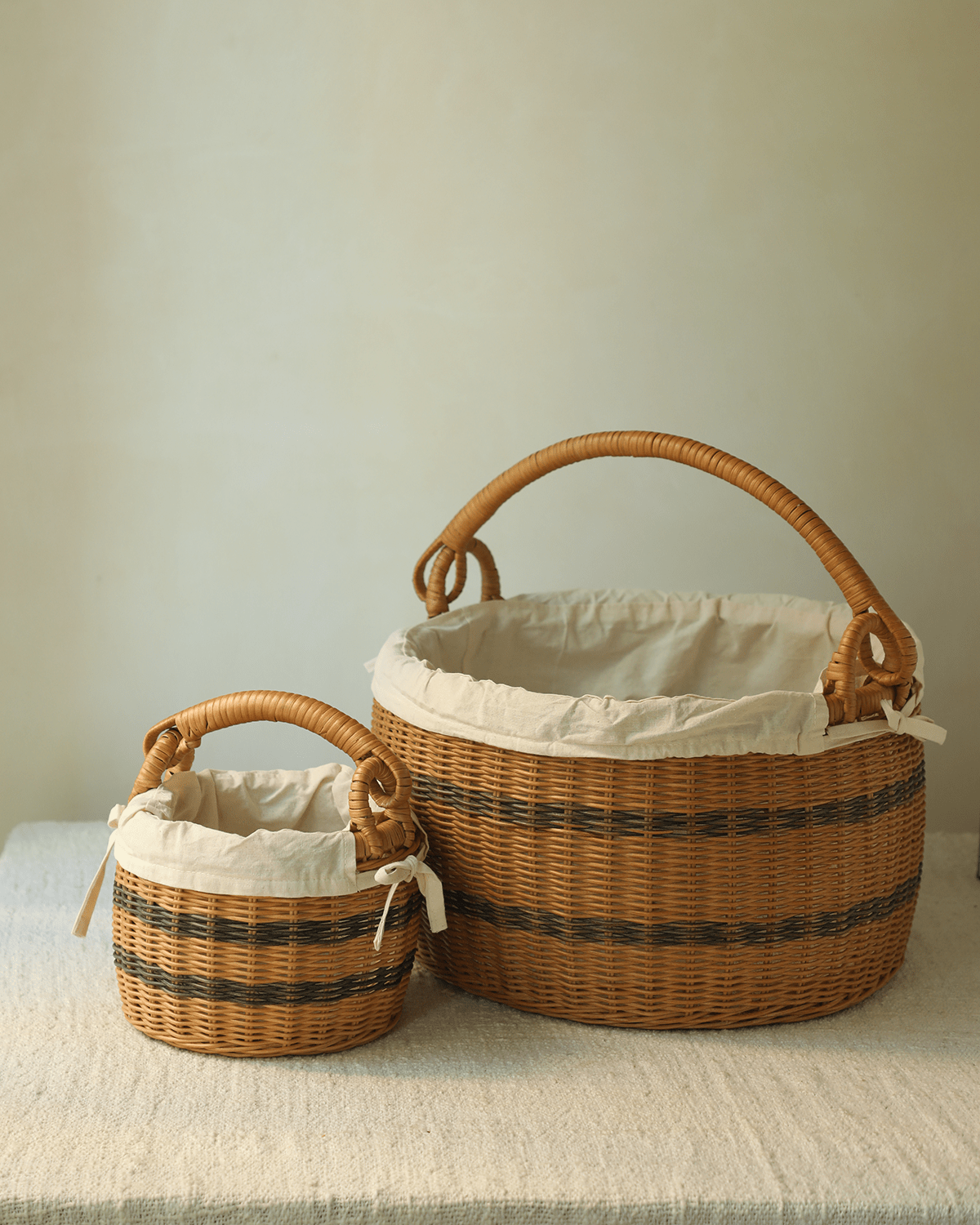 Sunday Picnic handwoven rattan bucket baskets with white cotton lining, large and small.