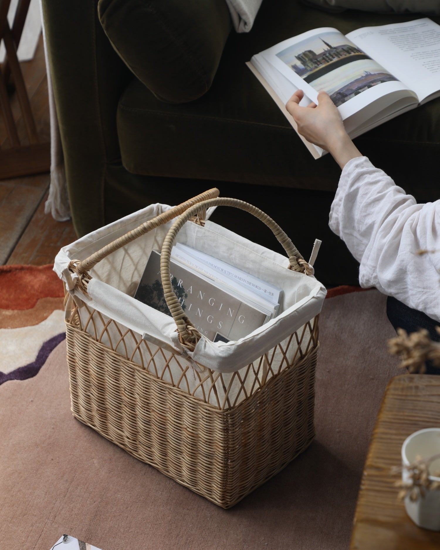 Lina woven rattan basket with dual-texture weave, cotton lining, and curved handles.