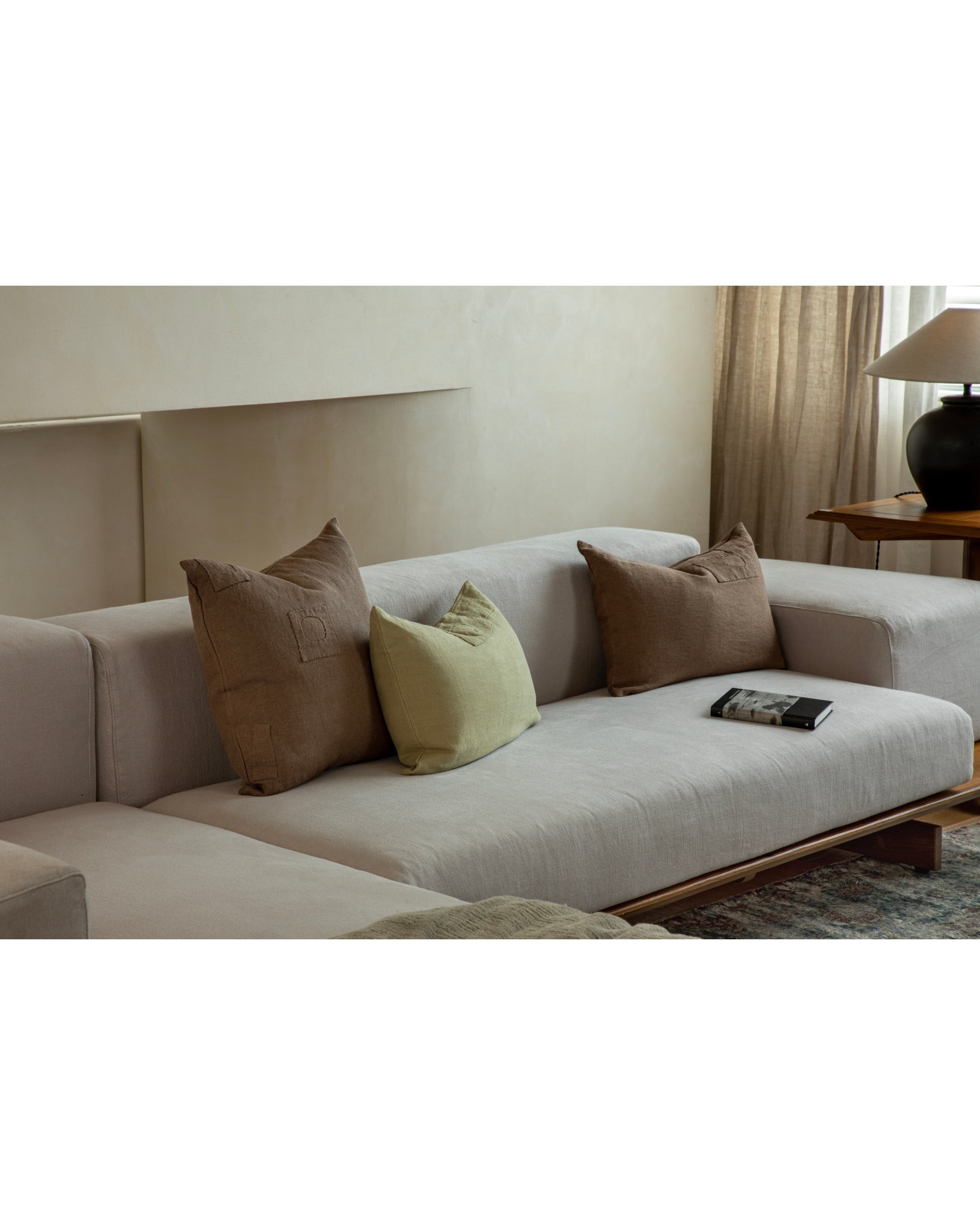 Linora yarn-dyed linen pillows in natural tones and sage green, featuring handcrafted patchwork.