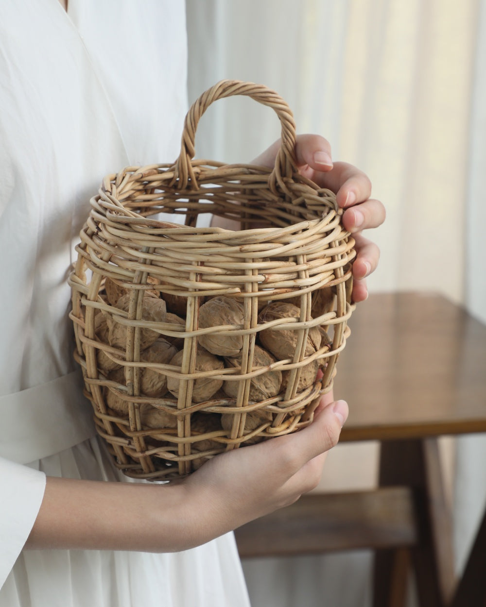 Cove hanging basket: hand-woven natural rattan, deep structure, airy texture, holding nuts.