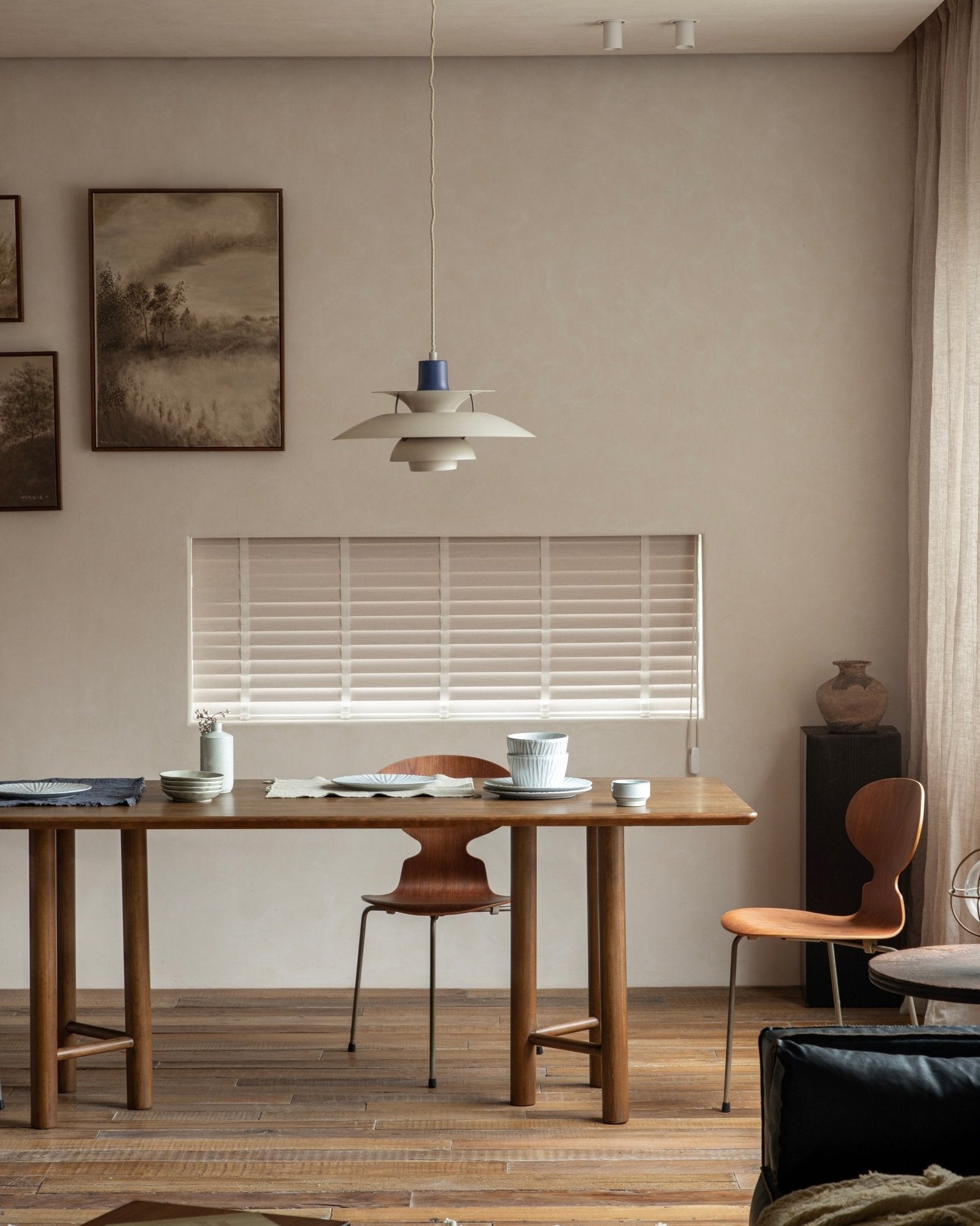 Columna dining table in cherry solid wood with unique column legs and triangular bracing.