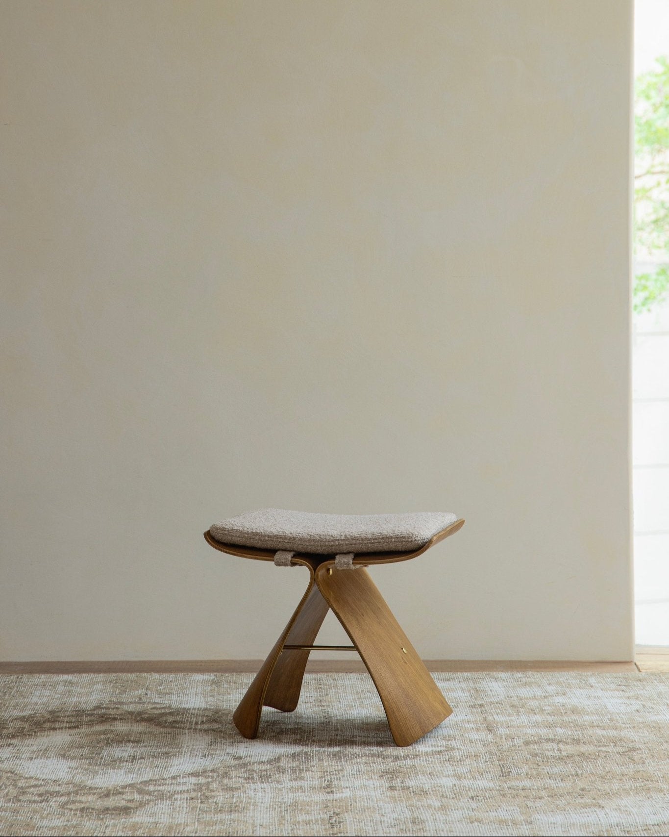 Butterfly Stool in light wood with neutral cushion, classic modern design, solid wood construction