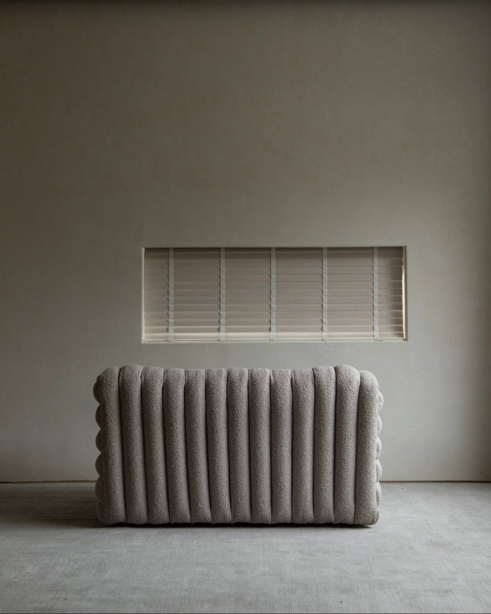 Miche Sofa in beige, vertical ribbed design, soft fabric, cozy living room setting, modern style.