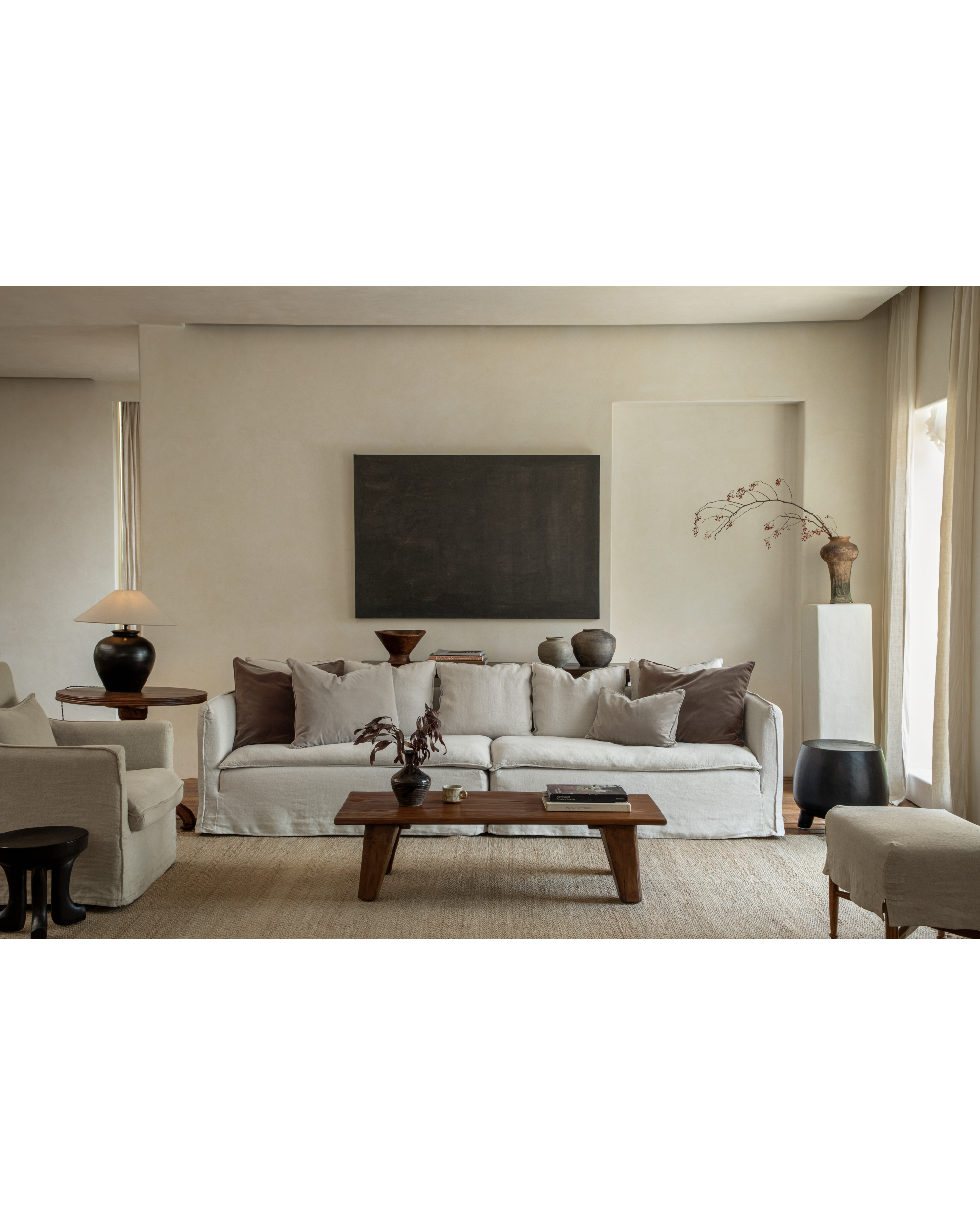 Camille Sectional Sofa in neutral linen, featuring plush cushions and a wood coffee table.