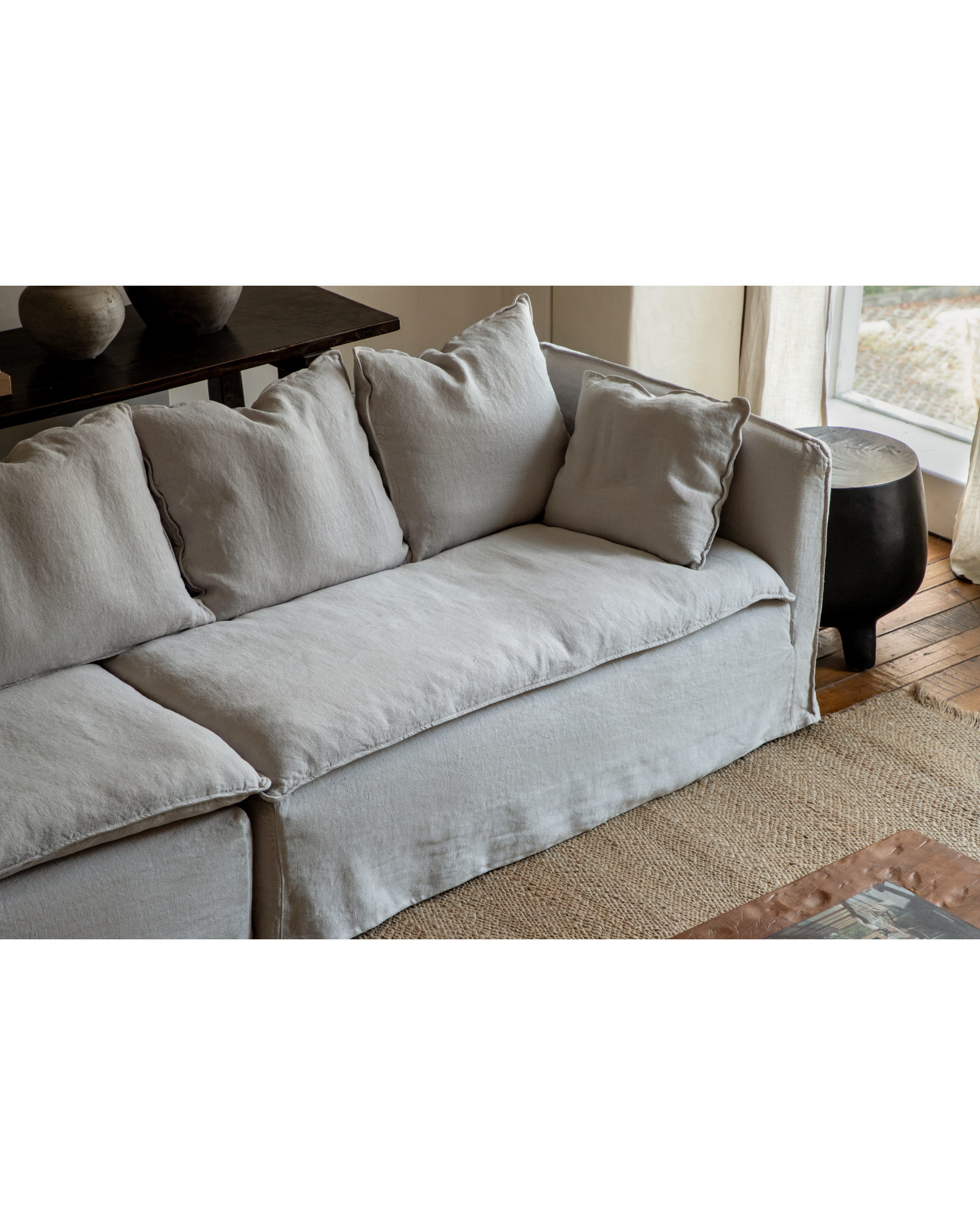 Camille sectional sofa in natural linen fabric with deep, plush cushions.