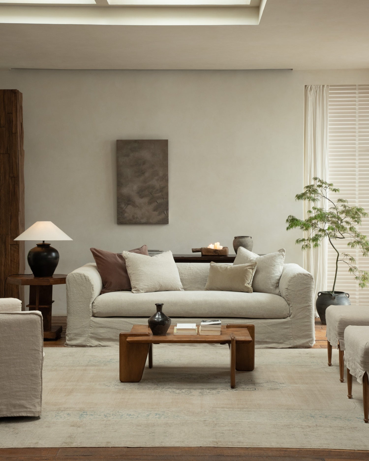 Charlotte Sofa in light linen upholstery, styled in a relaxed modern organic living room setting.